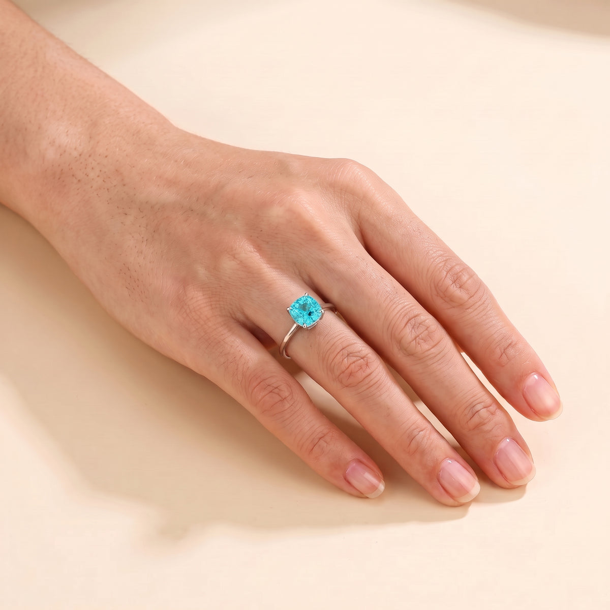 A model is wearing Iris Cushion Shape Paraiba Cathedral Solitaire