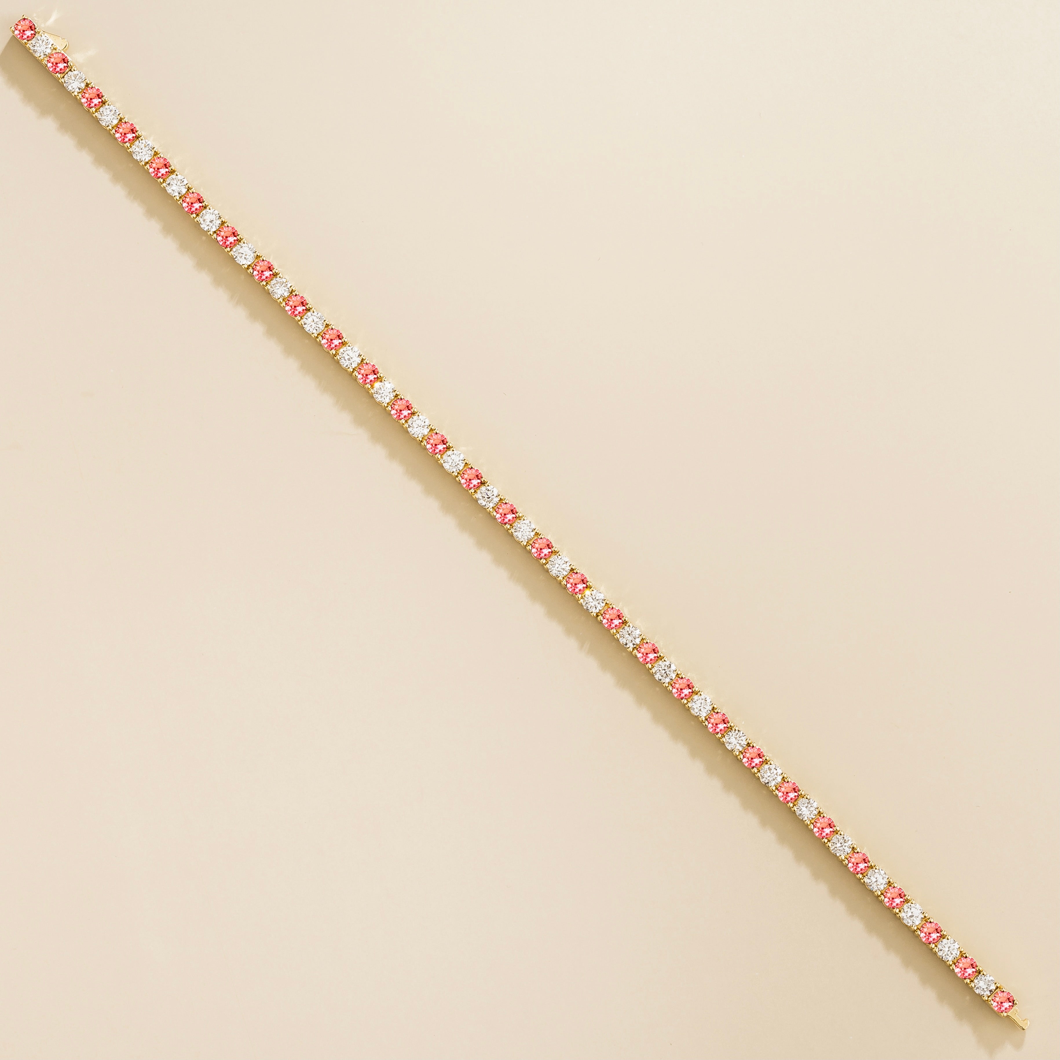 gold bracelet featuring round padparadscha sapphire gemstones and lab grown diamonds