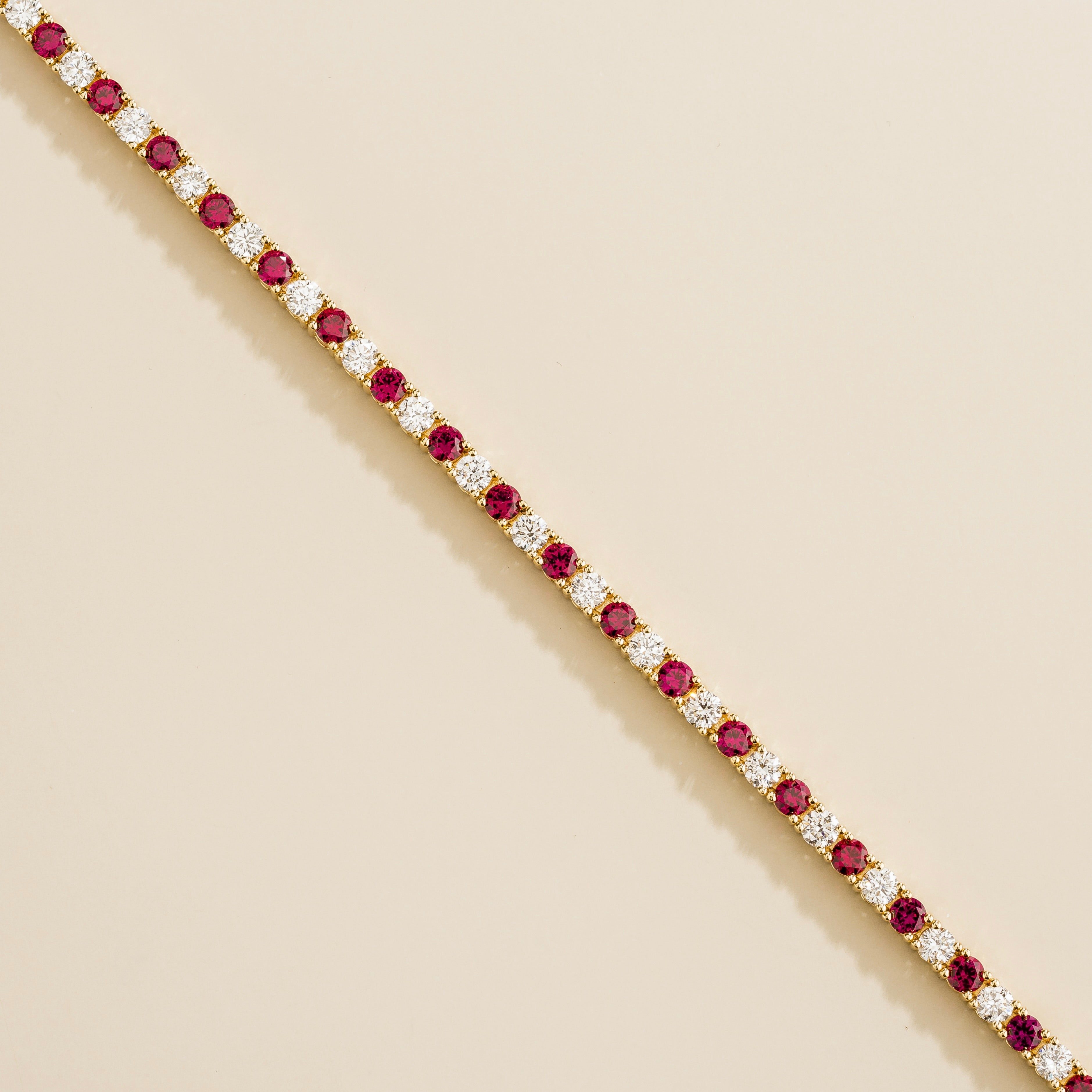 gold bracelet featuring round ruby gemstones and lab grown diamonds