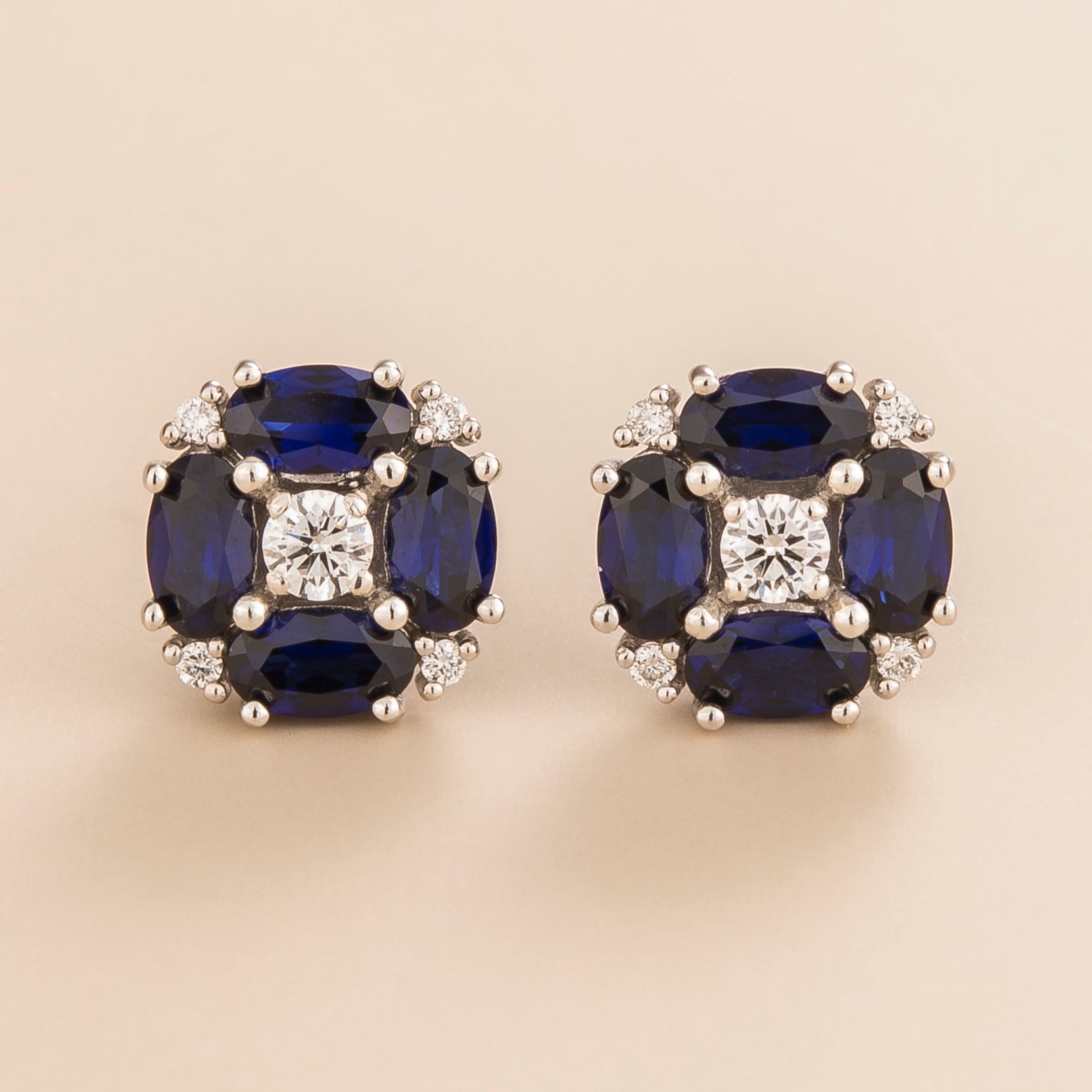 Pristi earrings in 18K white gold vermeil set with round lab grown Diamond and oval Blue Sapphire gem stones.