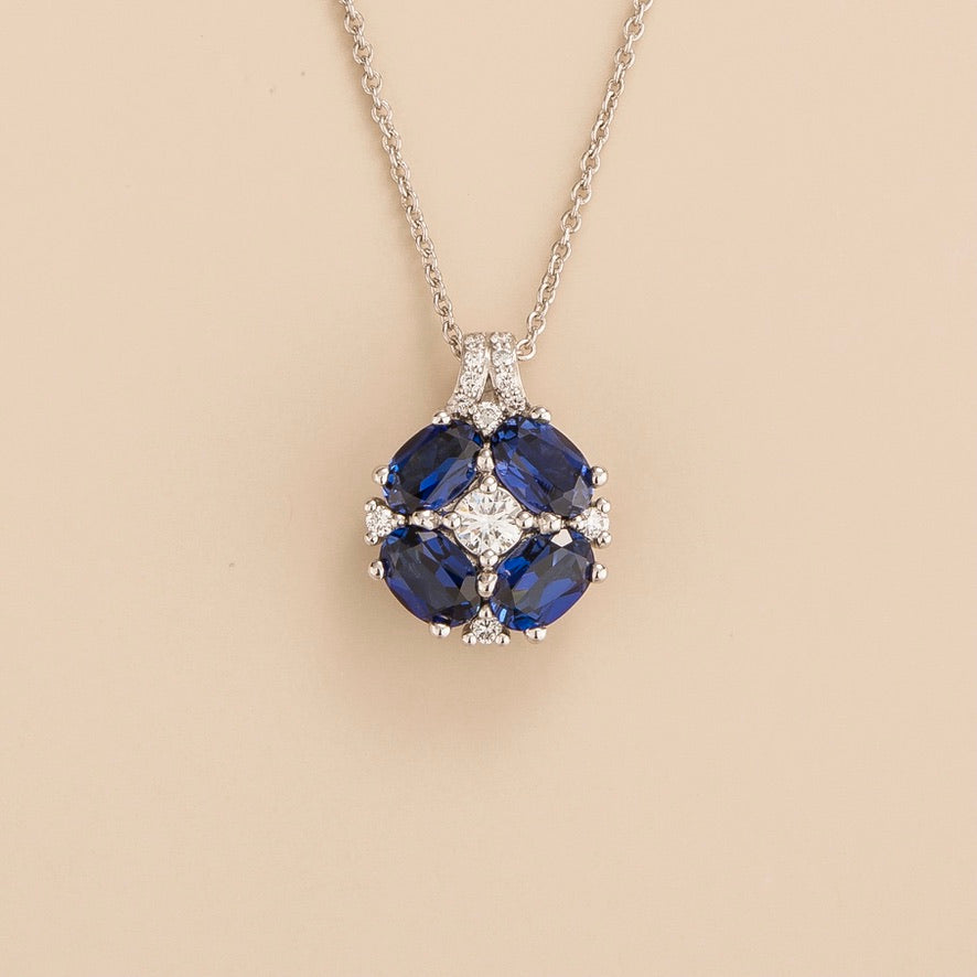 Pristi pendant necklace in 18K white gold vermeil set with lab grown Diamond and oval Blue Sapphire gem stones.