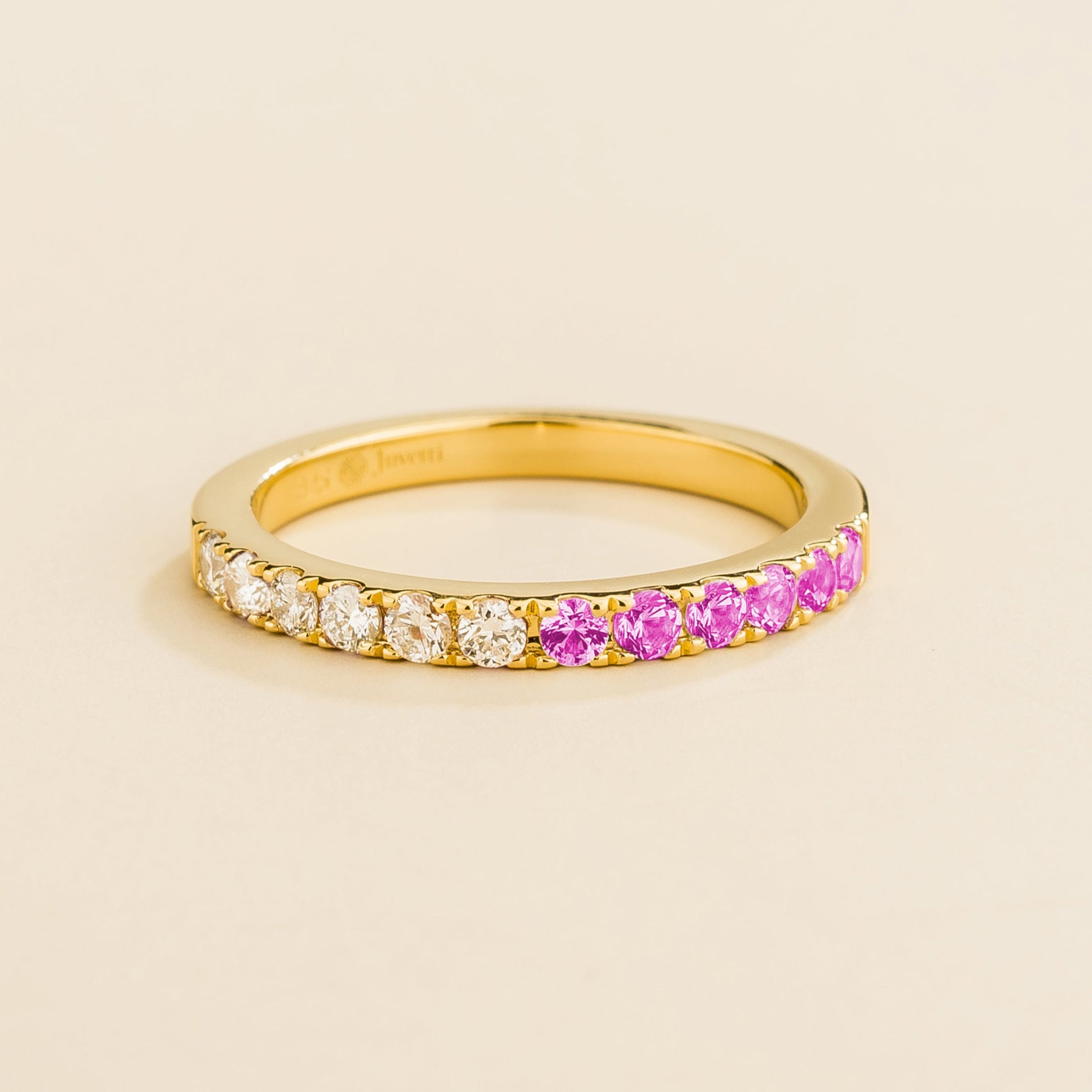 Juvetti yellow gold band featuring round lab-grown diamonds and pink sapphires set in a half-eternity design.