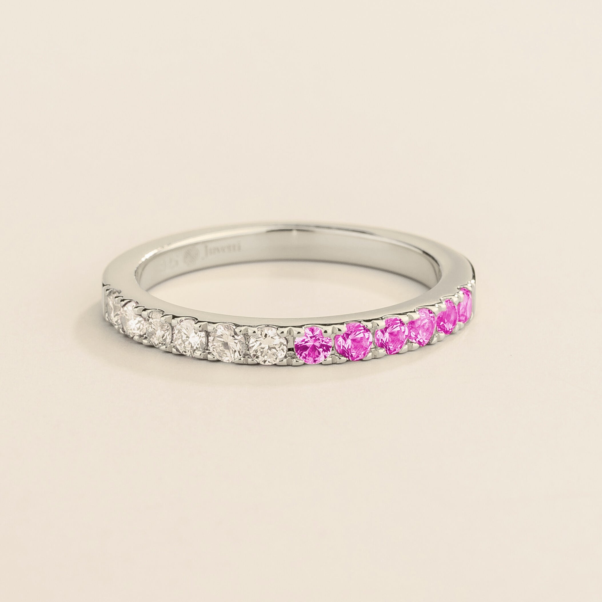 Juvetti white gold band featuring round lab-grown diamonds and pink sapphires set in a half-eternity design.