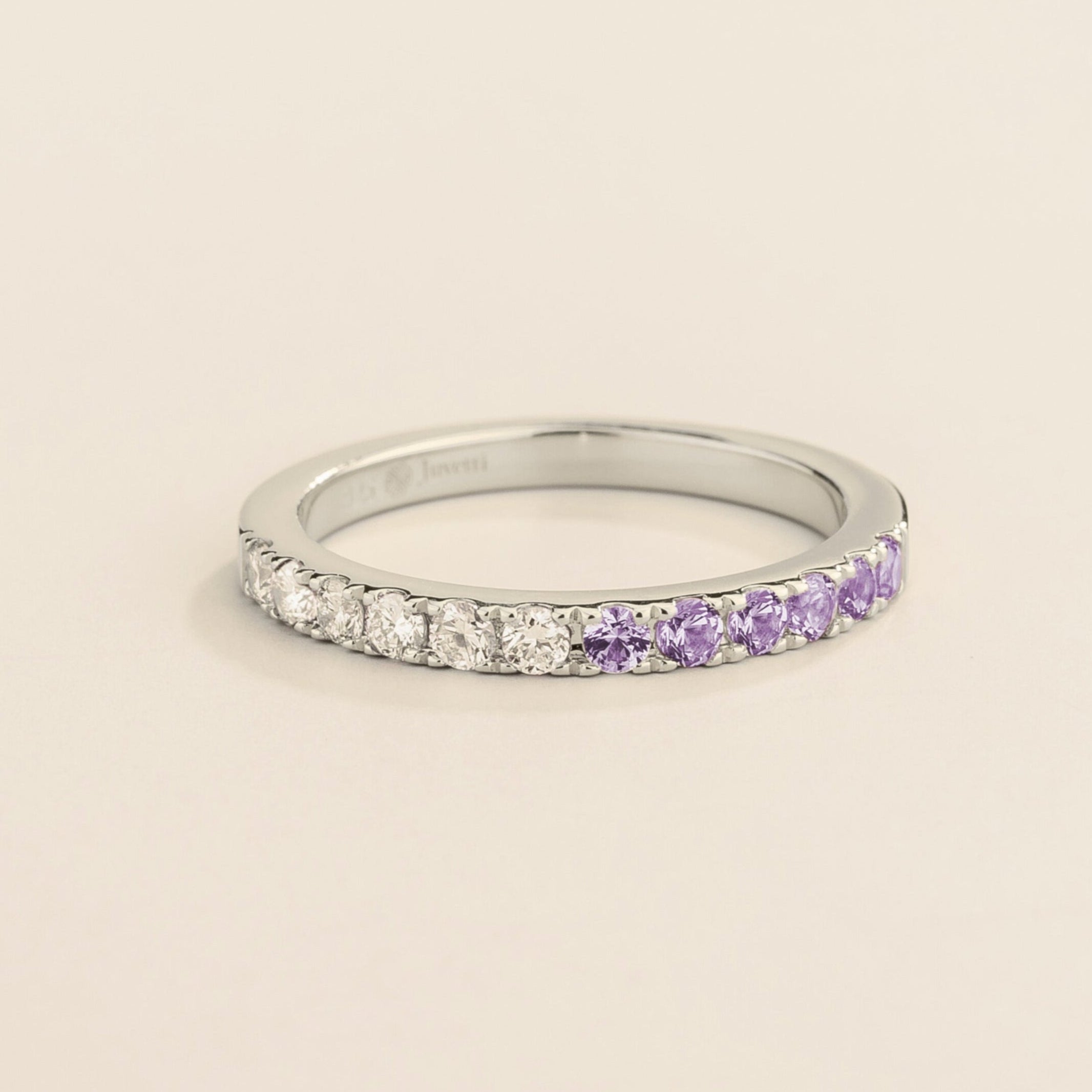 Juvetti white gold band featuring round lab-grown diamonds and purple sapphires set in a half-eternity design.