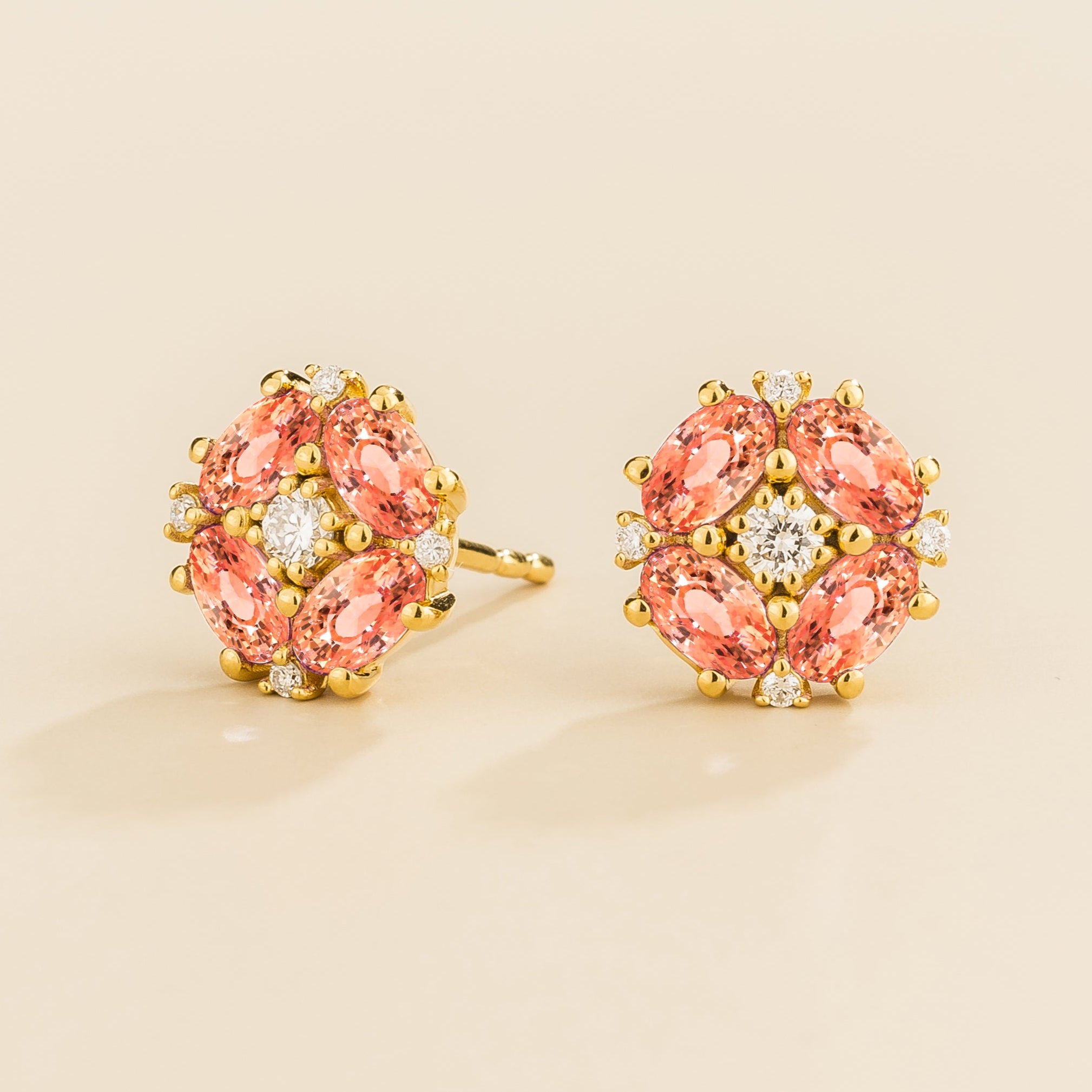 Gold earrings set with Padparadscha Sapphire and diamonds from Juvetti.