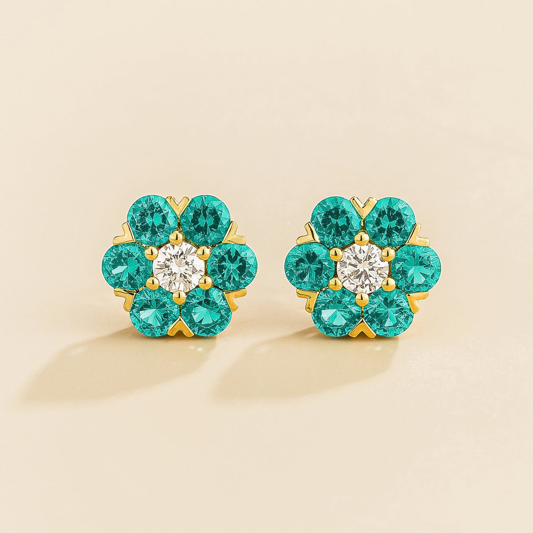 Cinq earrings in gold set with Diamonds and Paraiba Sapphires.