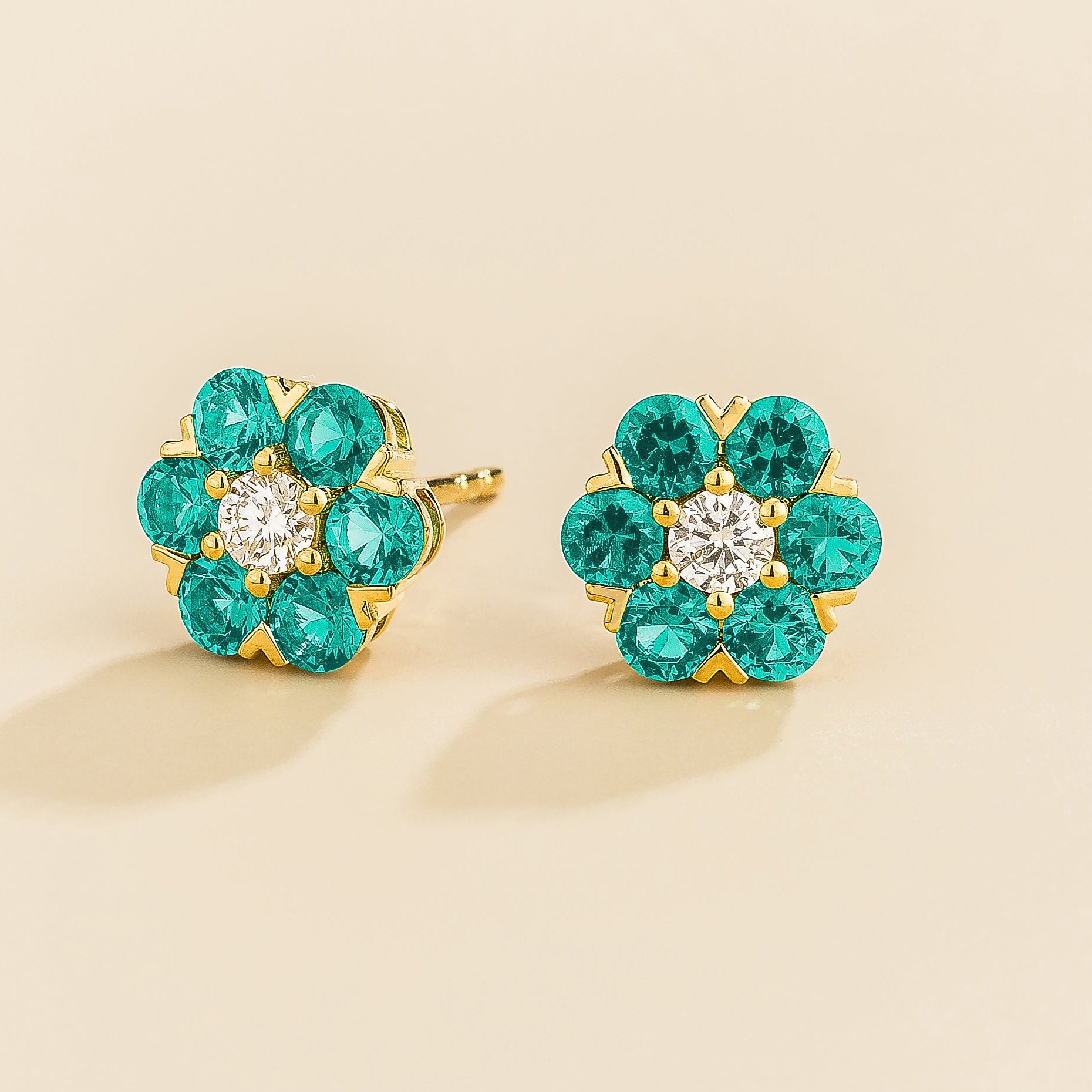 Cinq earrings in gold set with Diamonds and Paraiba Sapphires.