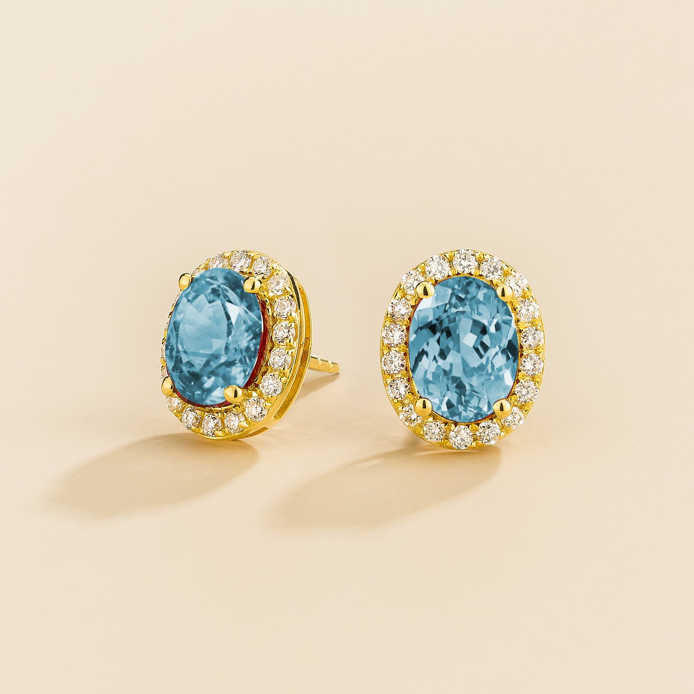 Mina earrings in a different angle with Aquamarine and diamonds set in gold