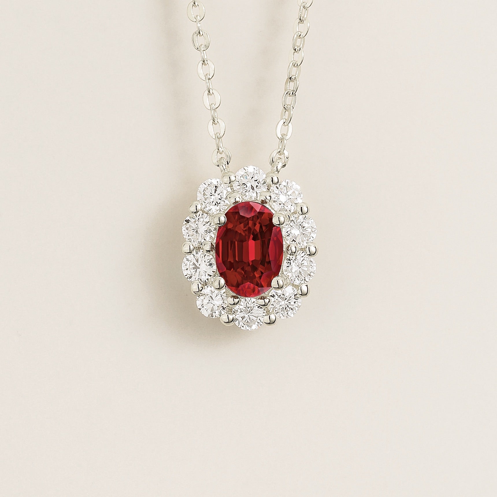 Prill Necklace with oval Ruby and round Halo Diamonds set in white gold. Juvetti Jewellery London Store
