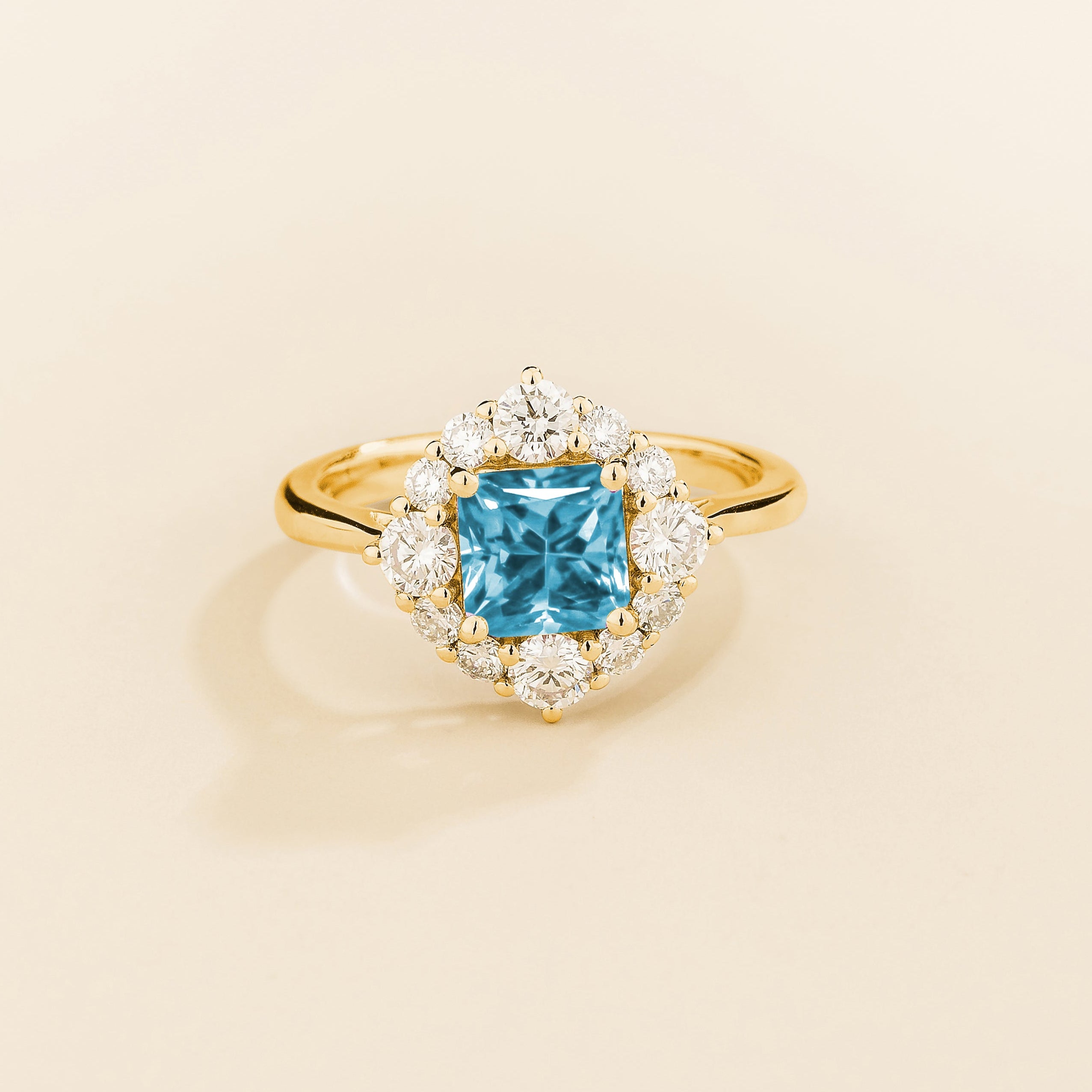 Juvetti gold ring featuring an octagon-cut lab-grown aquamarine surrounded by round brilliant lab-grown diamonds in a halo design.