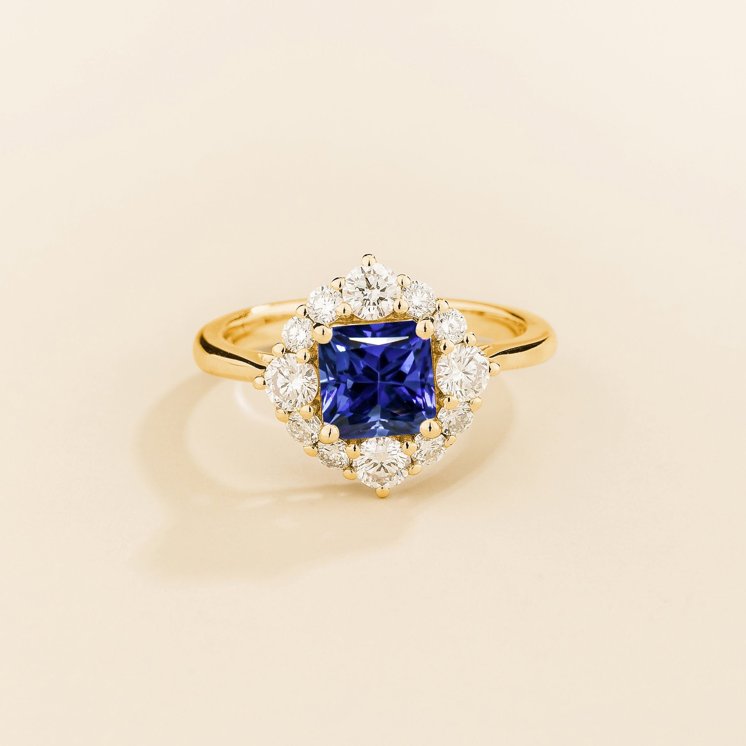 Juvetti gold ring featuring an octagon-cut lab-grown royal blue sapphire surrounded by round brilliant lab-grown diamonds in a halo design.