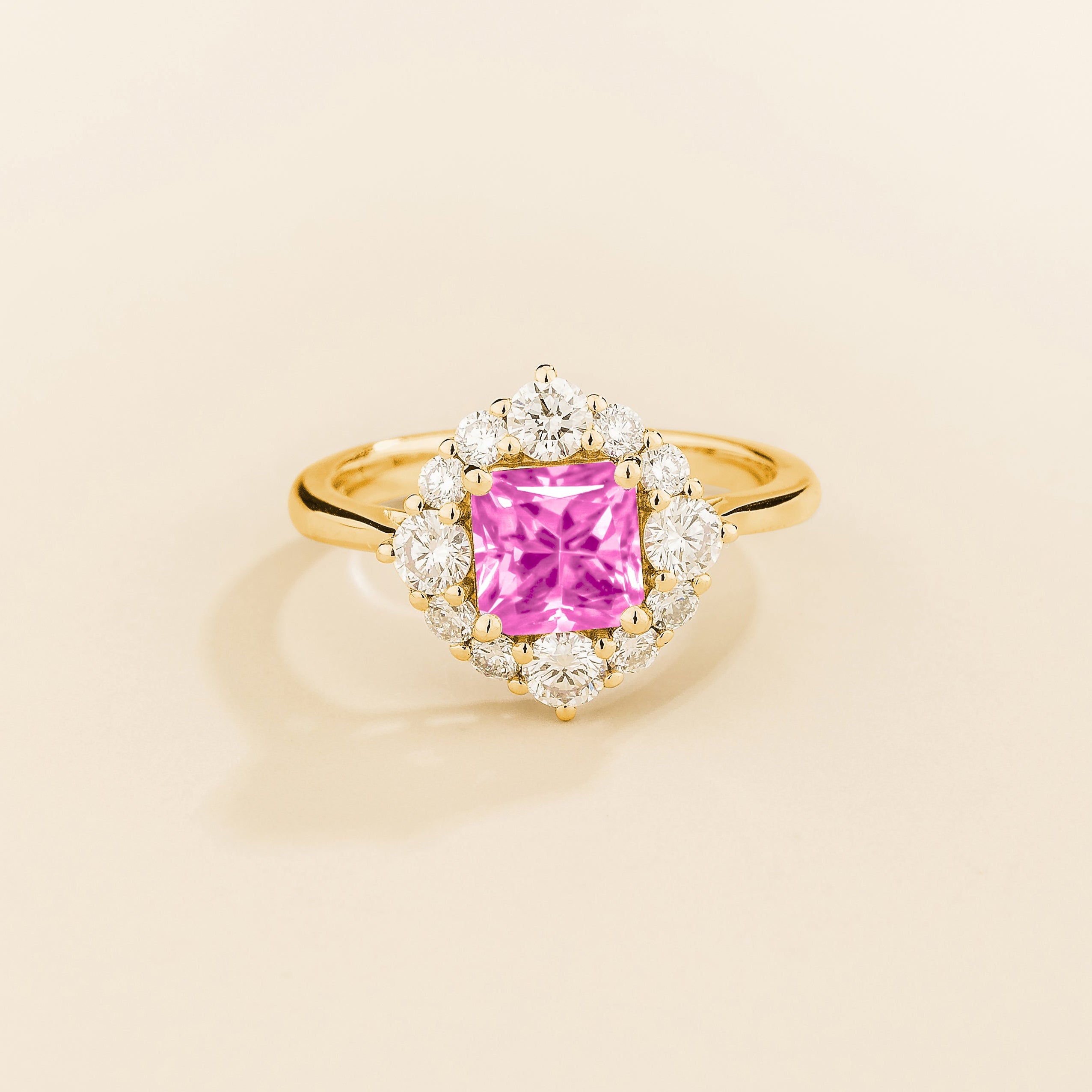 Juvetti gold ring featuring an octagon-cut lab-grown pink sapphire surrounded by round brilliant lab-grown diamonds in a halo design.
