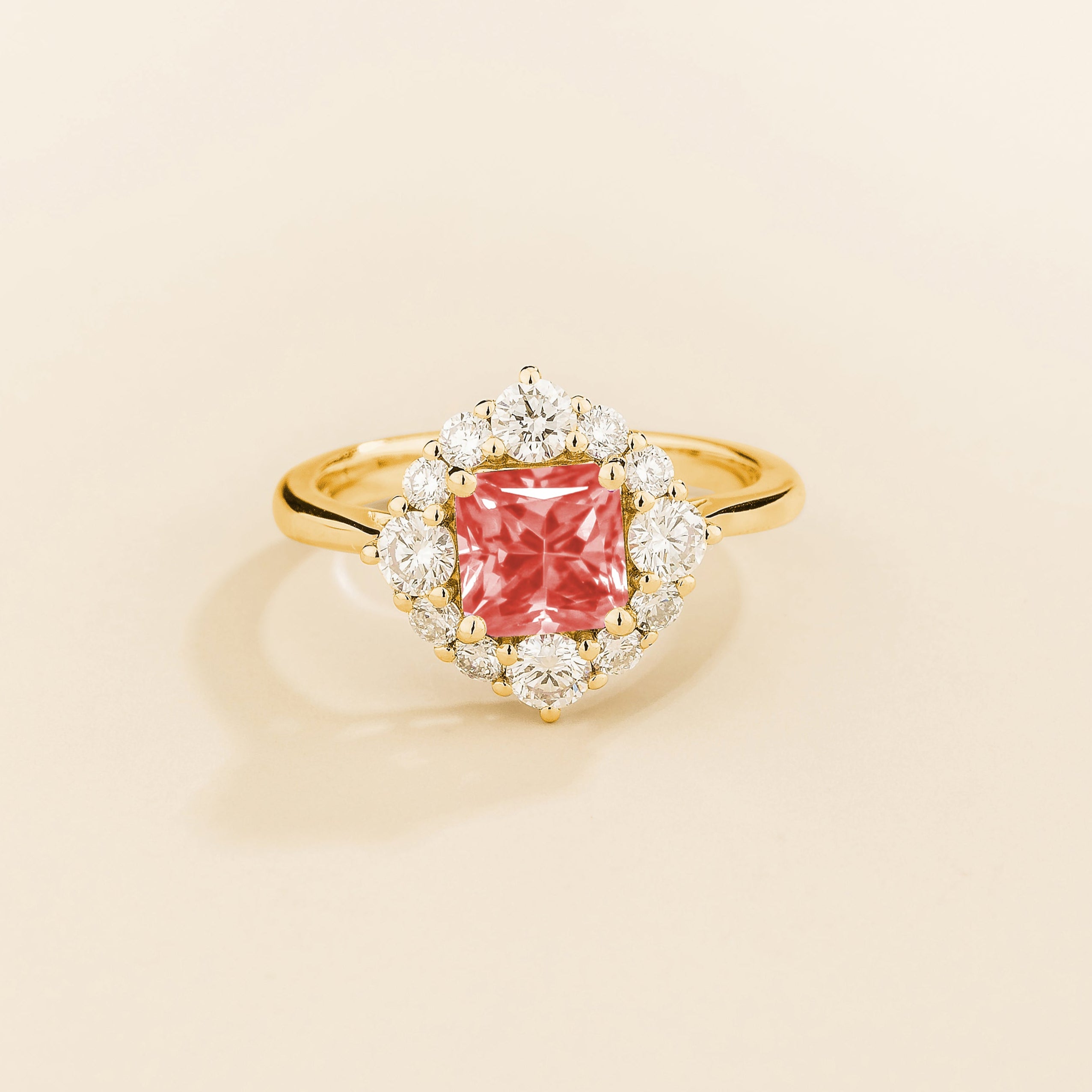Juvetti gold ring featuring an octagon-cut lab-grown padparadscha sapphire surrounded by round brilliant lab-grown diamonds in a halo design.