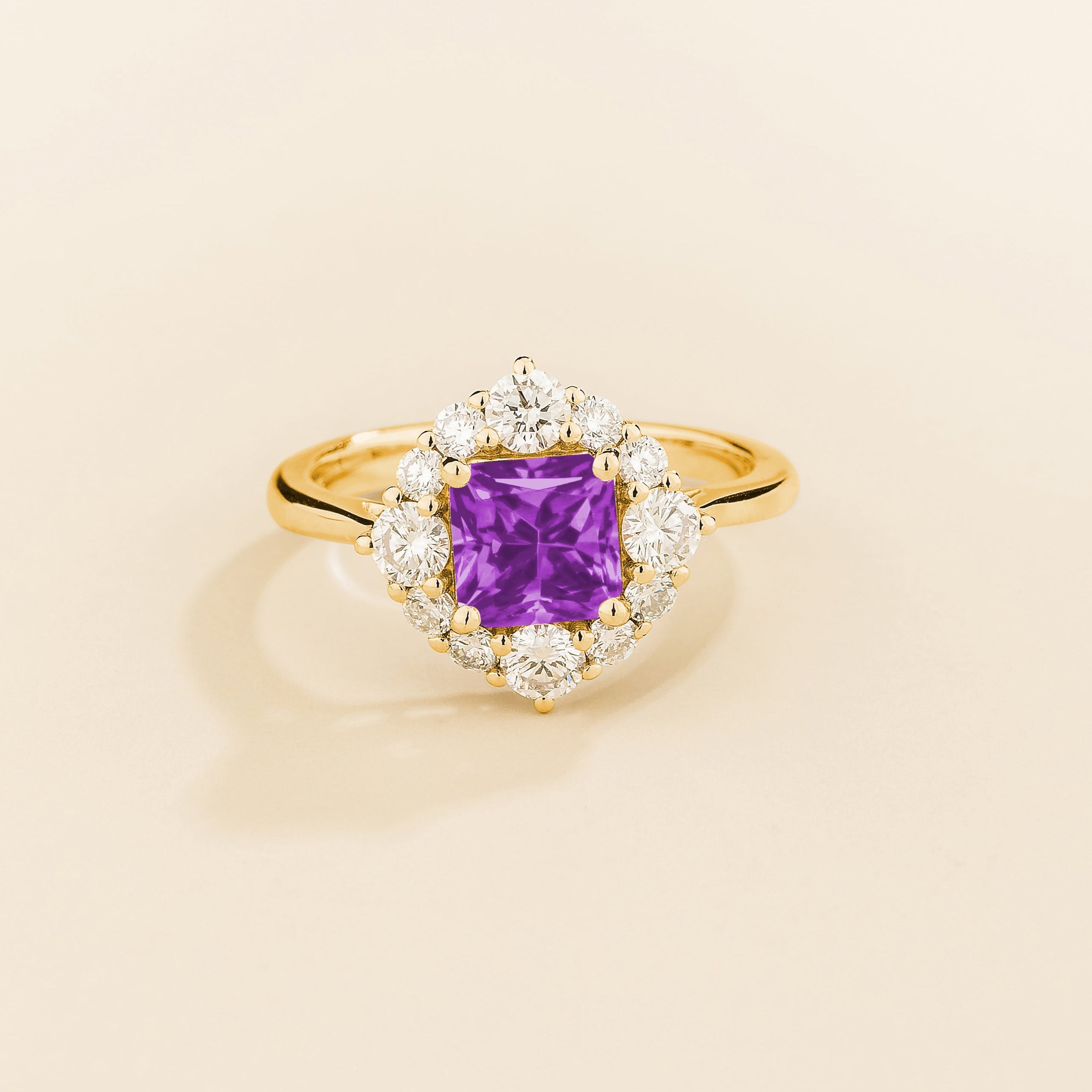 Juvetti gold ring featuring an octagon-cut lab-grown purple sapphire surrounded by round brilliant lab-grown diamonds in a halo design.