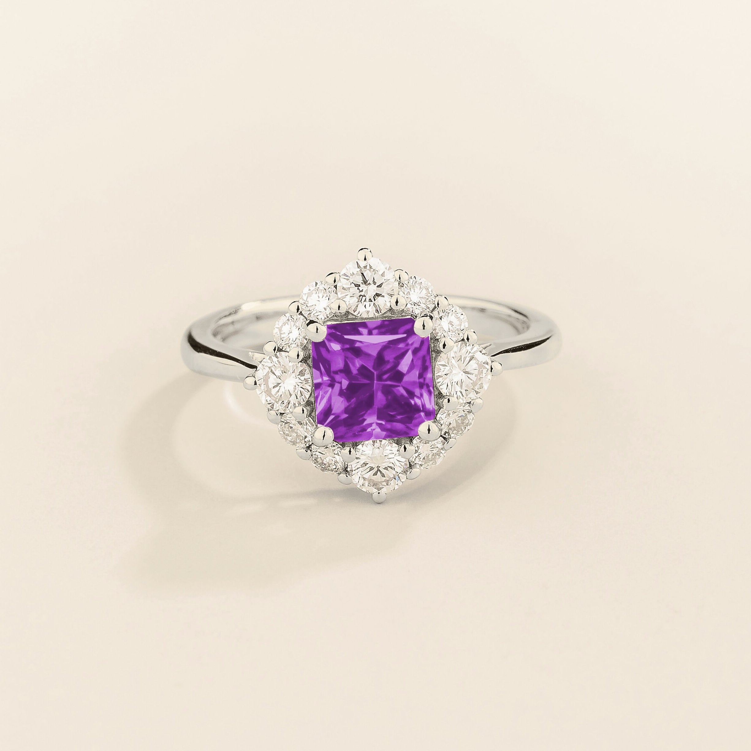 Juvetti white gold ring featuring an octagon-cut lab-grown purple sapphire surrounded by round brilliant lab-grown diamonds in a halo design.