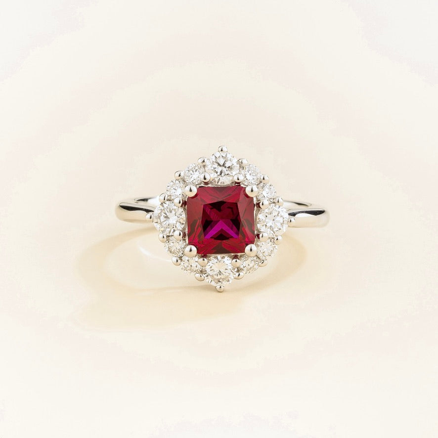 Juvetti white gold ring featuring an octagon-cut lab-grown ruby surrounded by round brilliant lab-grown diamonds in a halo design.