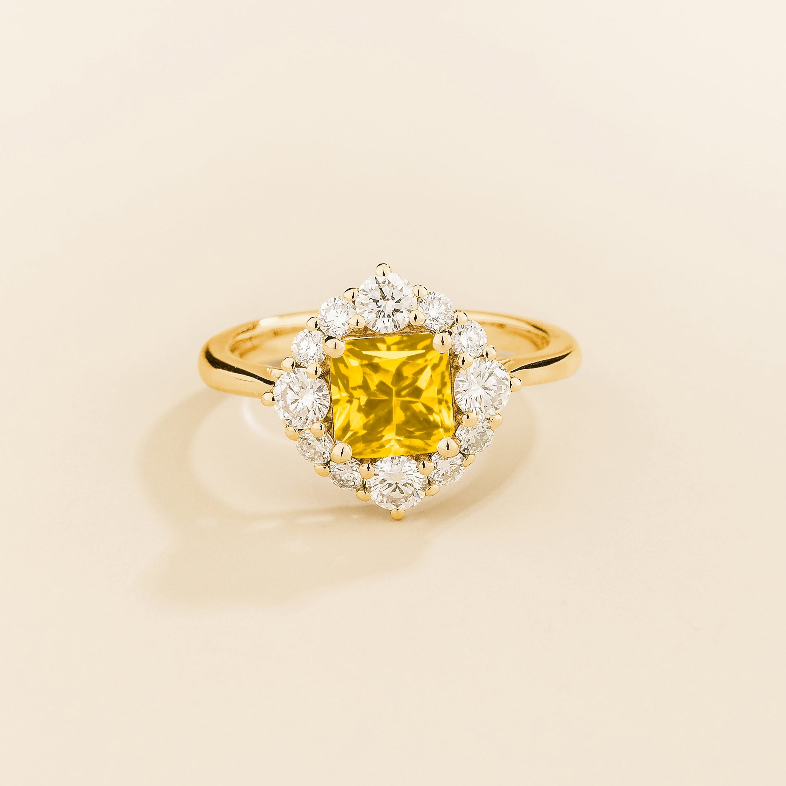 Juvetti gold ring featuring an octagon-cut lab-grown yellow sapphire surrounded by round brilliant lab-grown diamonds in a halo design.