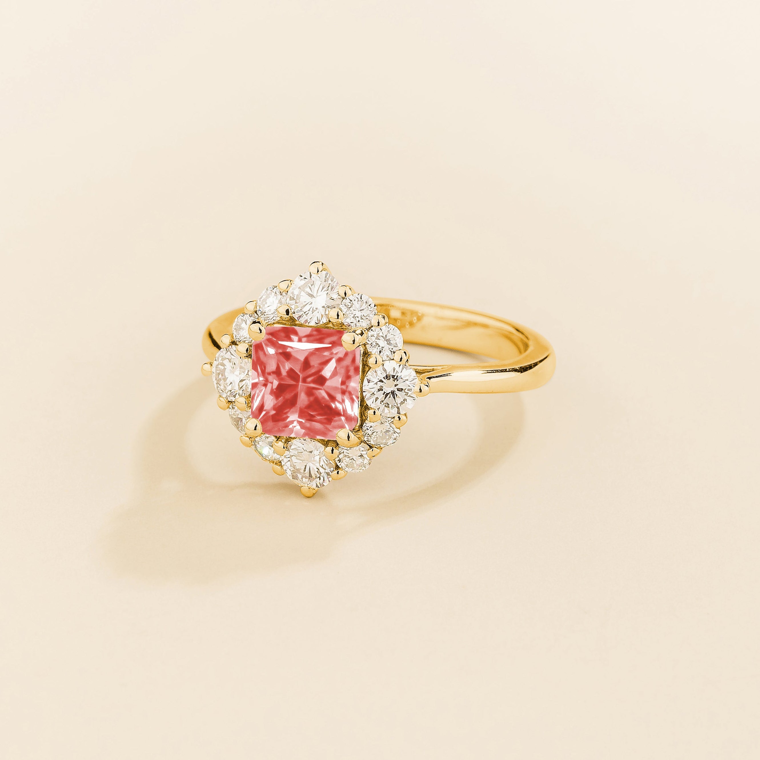 Tuli halo ring in gold set with Padparadscha Sapphire and Diamonds.