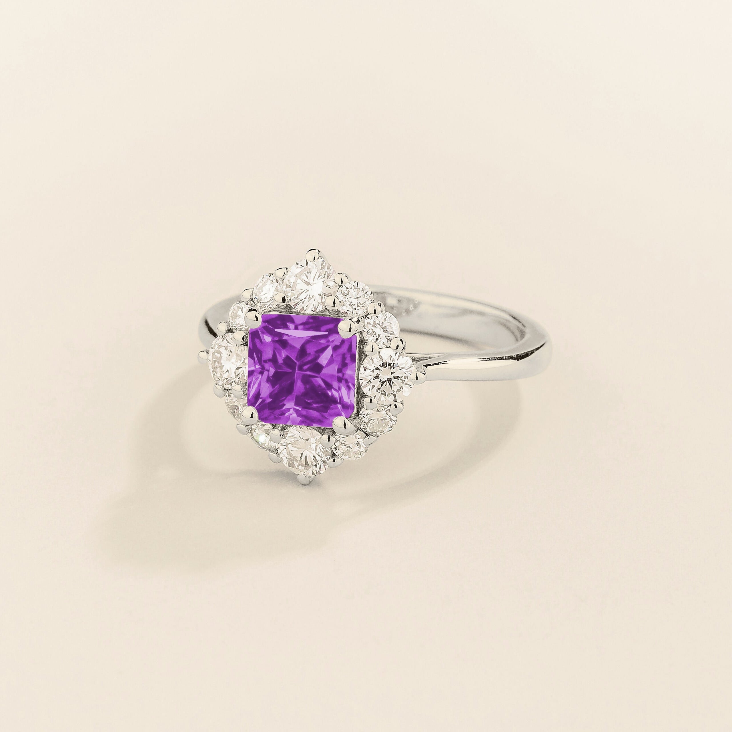 Tuli halo ring in white gold set with Purple Sapphire and Diamonds.