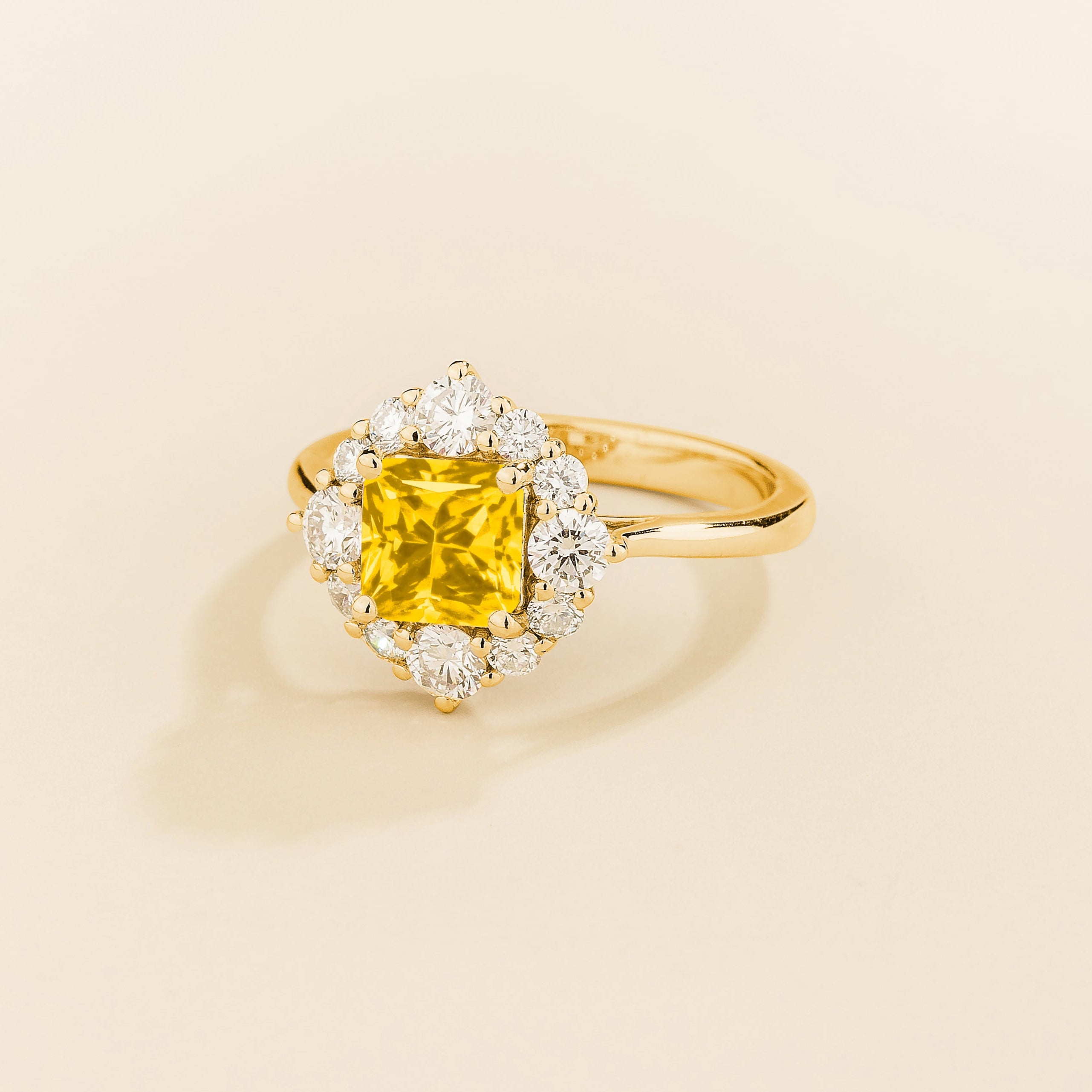 Tuli halo ring in gold set with Yellow Sapphire and Diamonds.