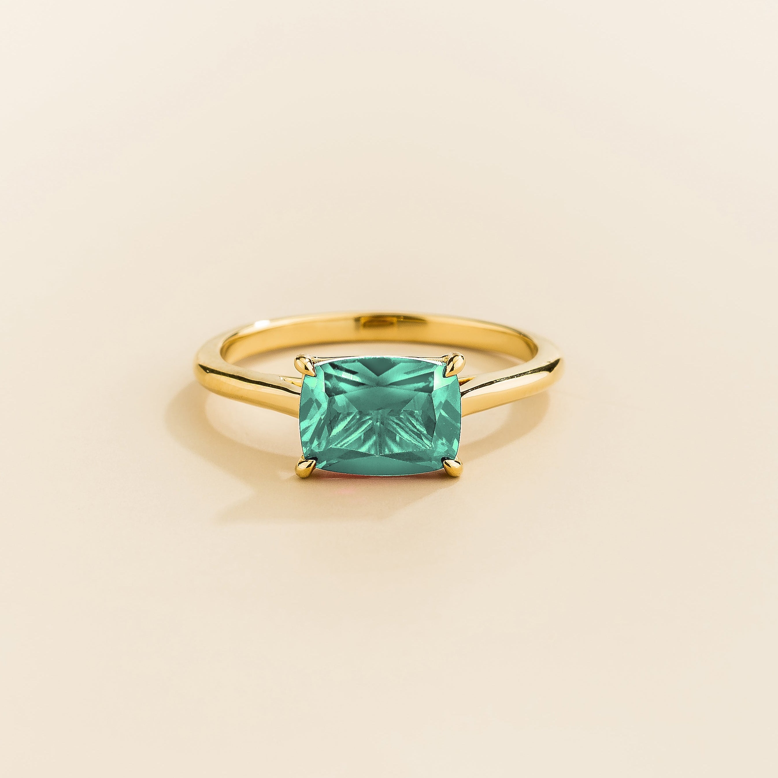 Kissen Ring in gold, set with a Paraiba Sapphire in an eastāwest setting.