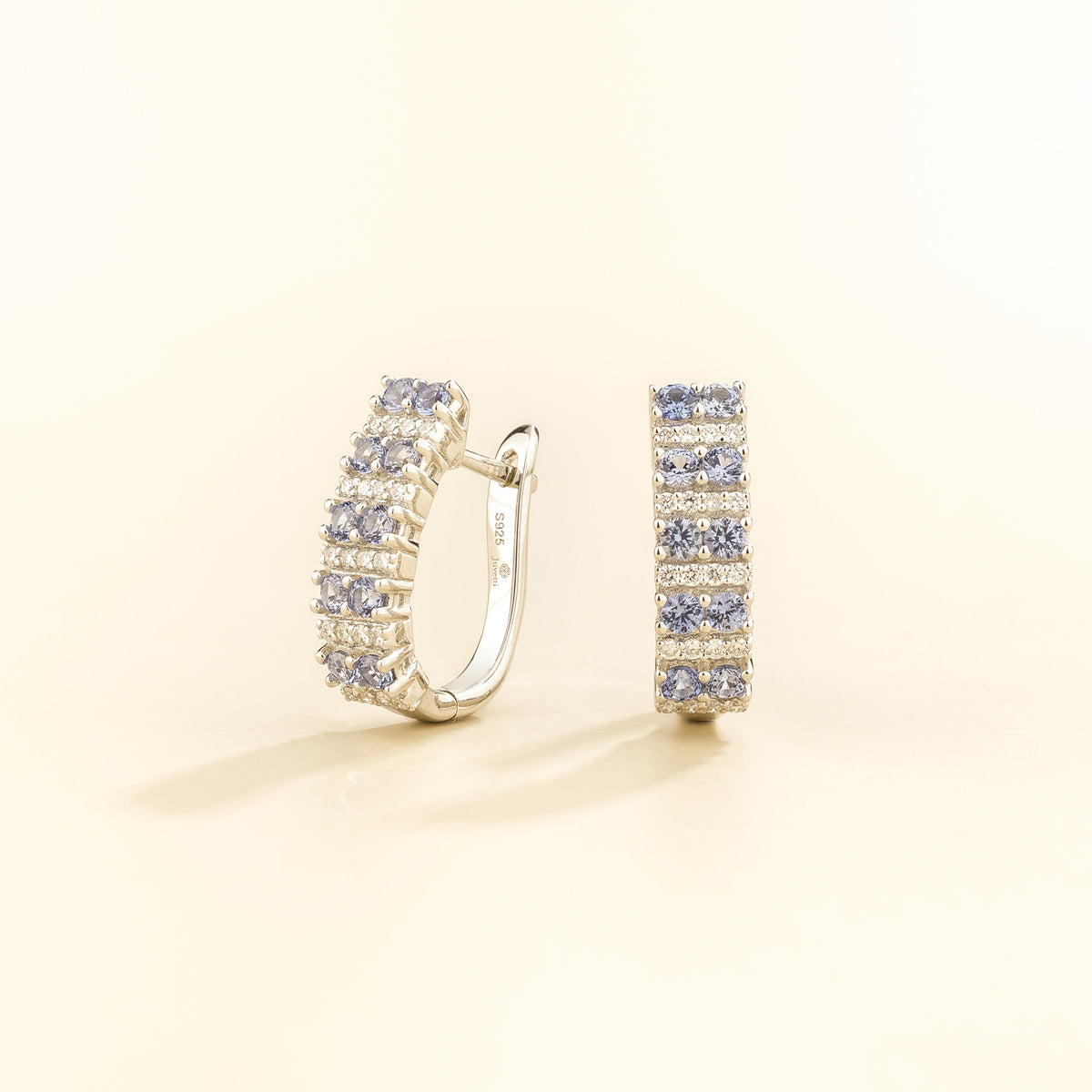 Tina pastel blue sapphire & diamond huggie hoop earrings in white gold, three-quarter view | Juvetti