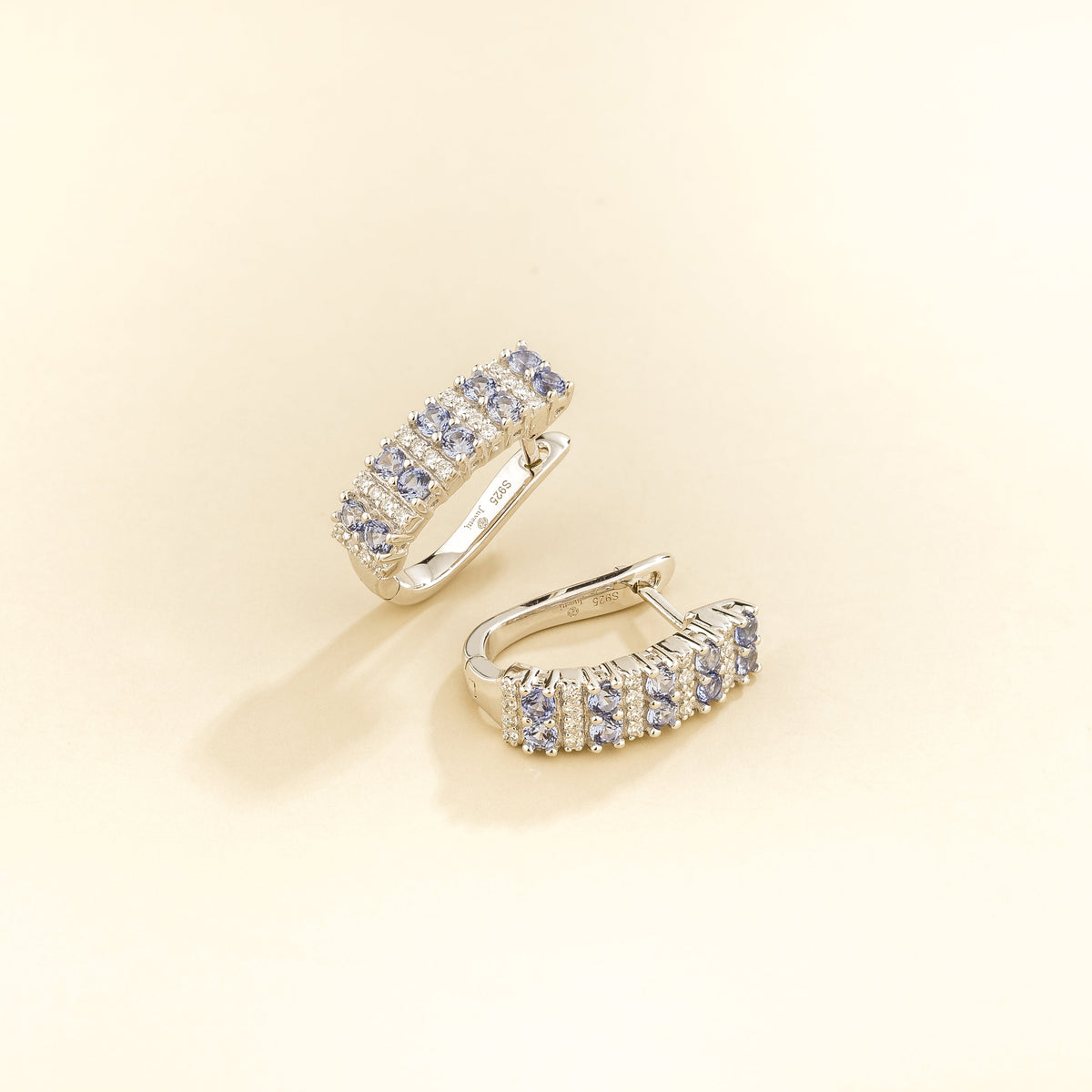 Tina pastel blue sapphire & diamond huggie hoop earrings in white gold, angled view
