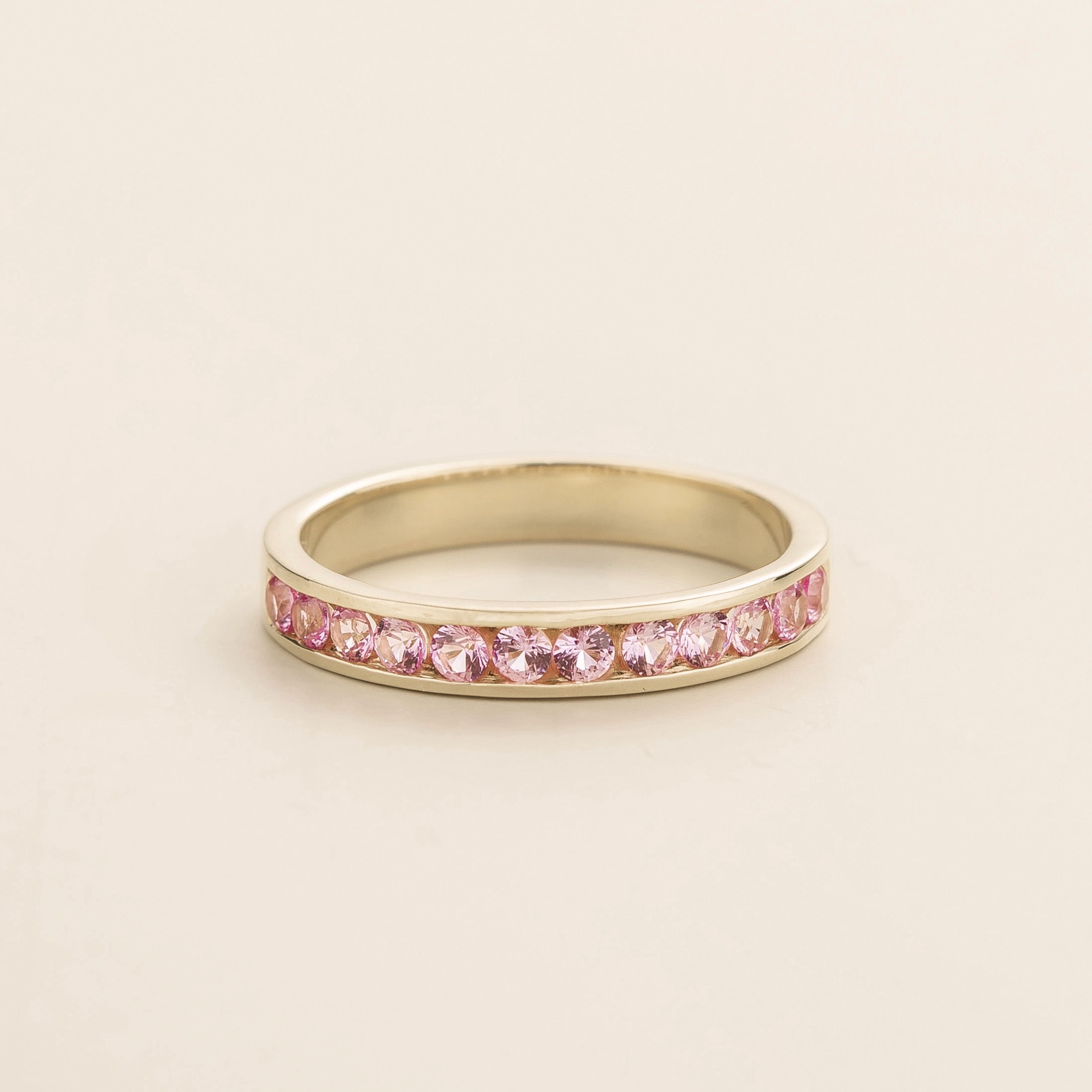 Juvetti white gold channel-set band featuring round lab-grown pink sapphires.