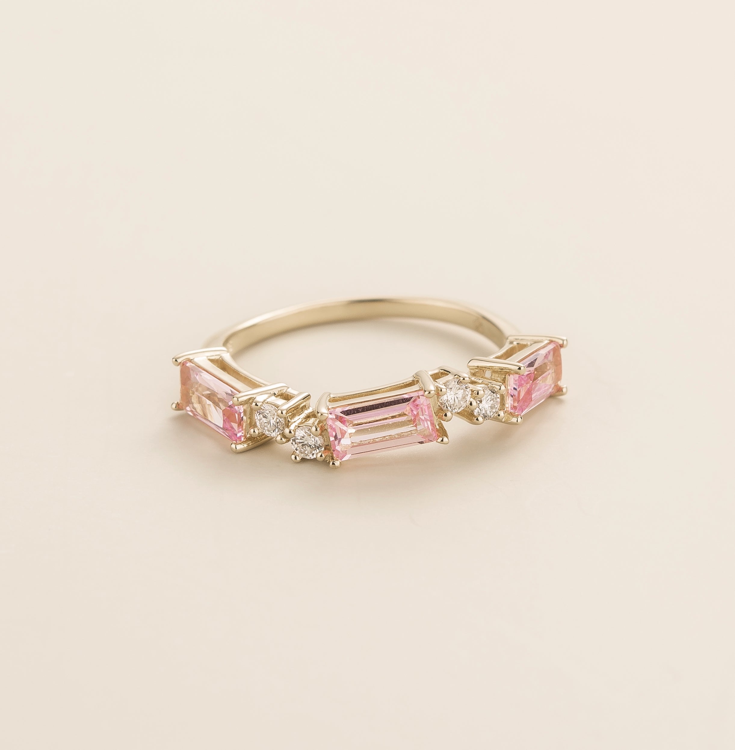 Juvetti white gold ring showcasing ethical lab-grown baguette-cut pink sapphires and round brilliant diamonds.