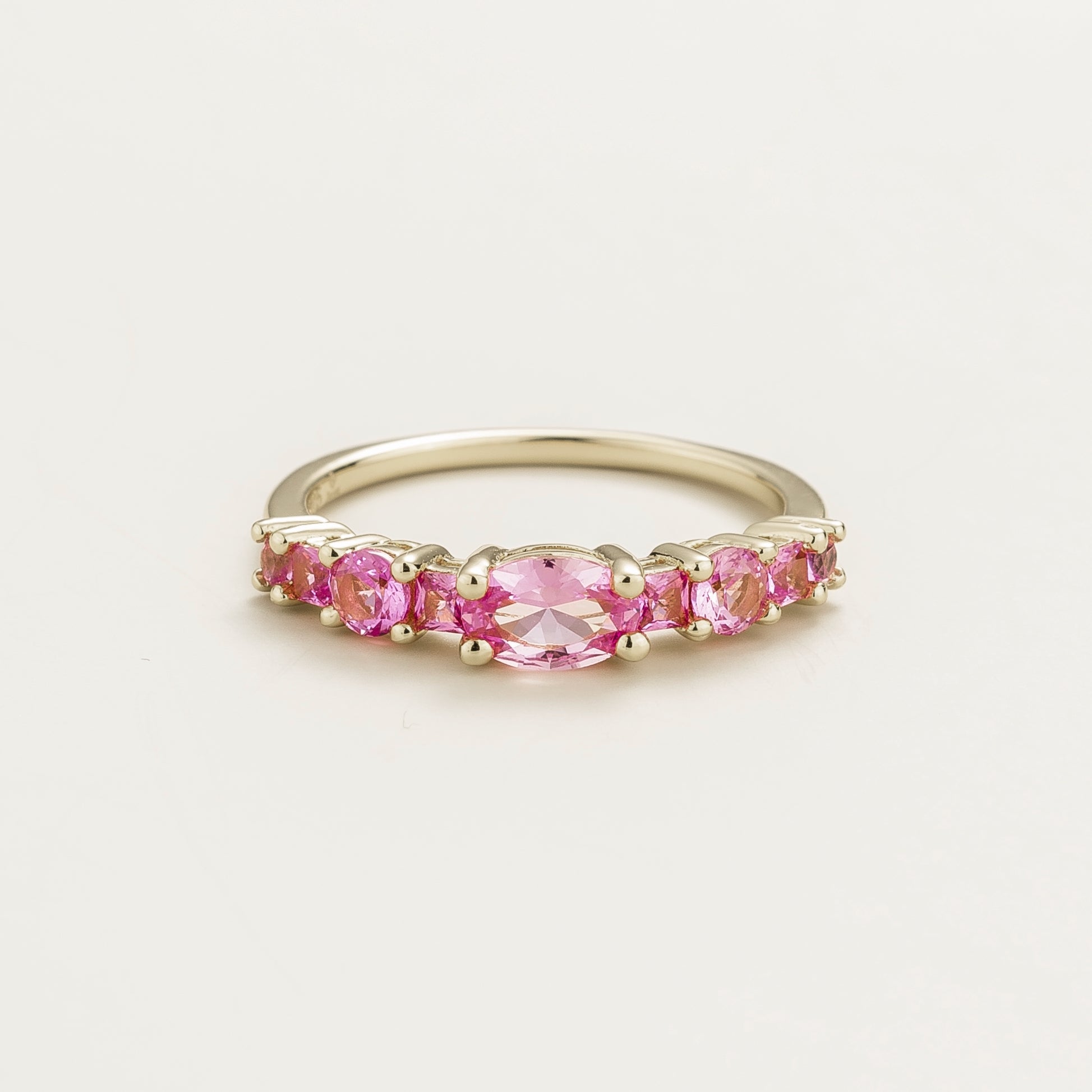 Juvetti white gold ring featuring lab-grown pink sapphire in oval, princess, and round cuts for a timeless half-eternity look.