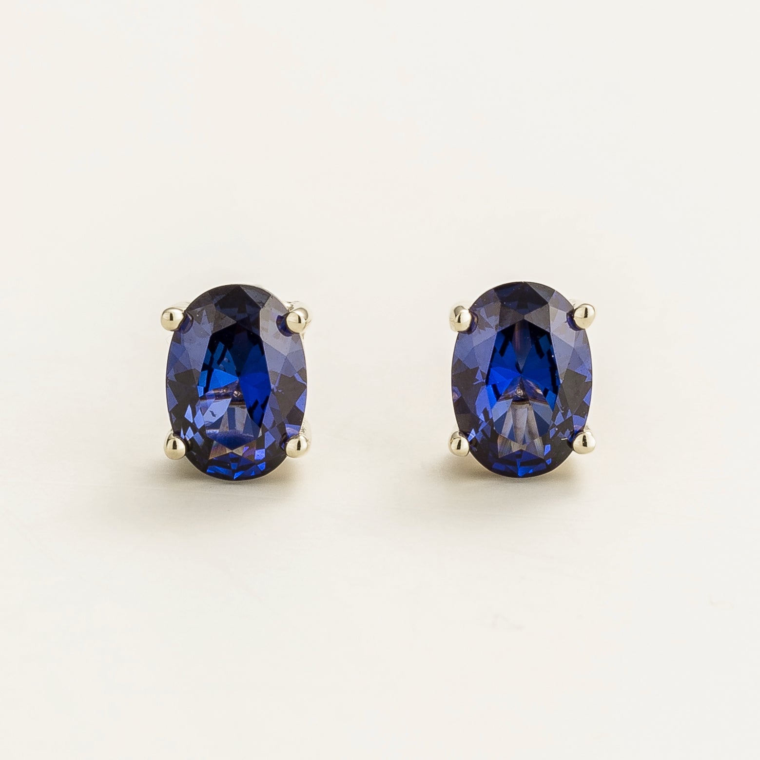 Ovo Blue Sapphire Oval Stud Earrings in White Gold
