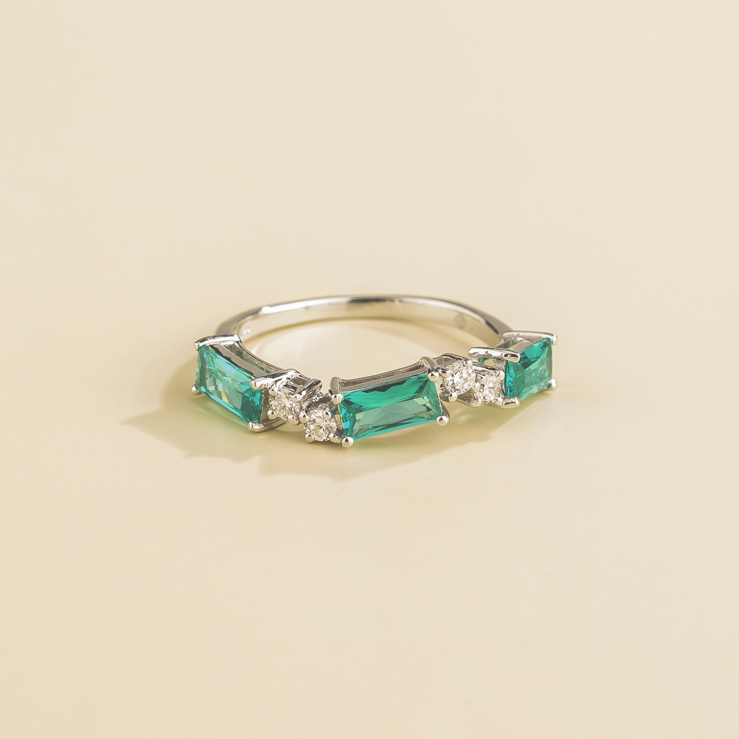 Juvetti white gold ring showcasing ethical lab-grown baguette-cut paraiba sapphires and round brilliant diamonds.
