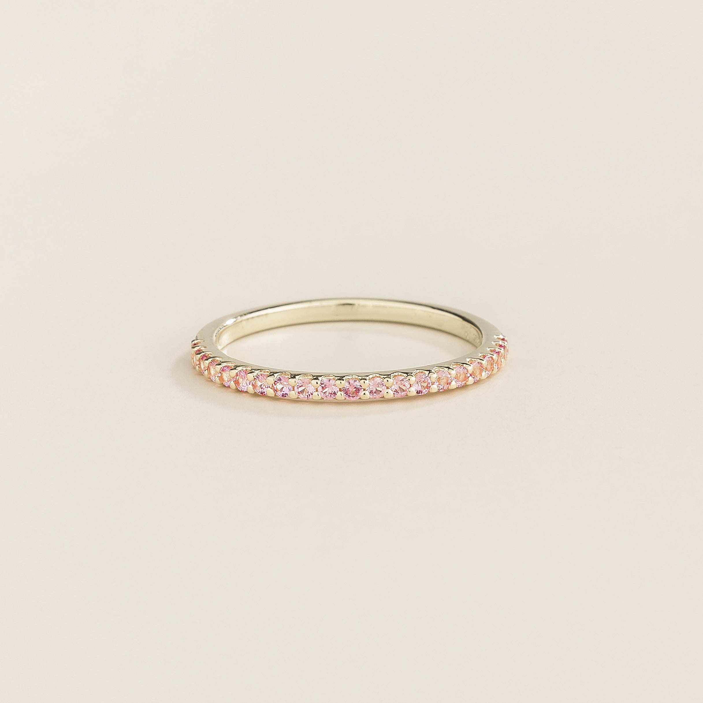 Juvetti white gold half eternity band set with round lab-grown pink sapphires.