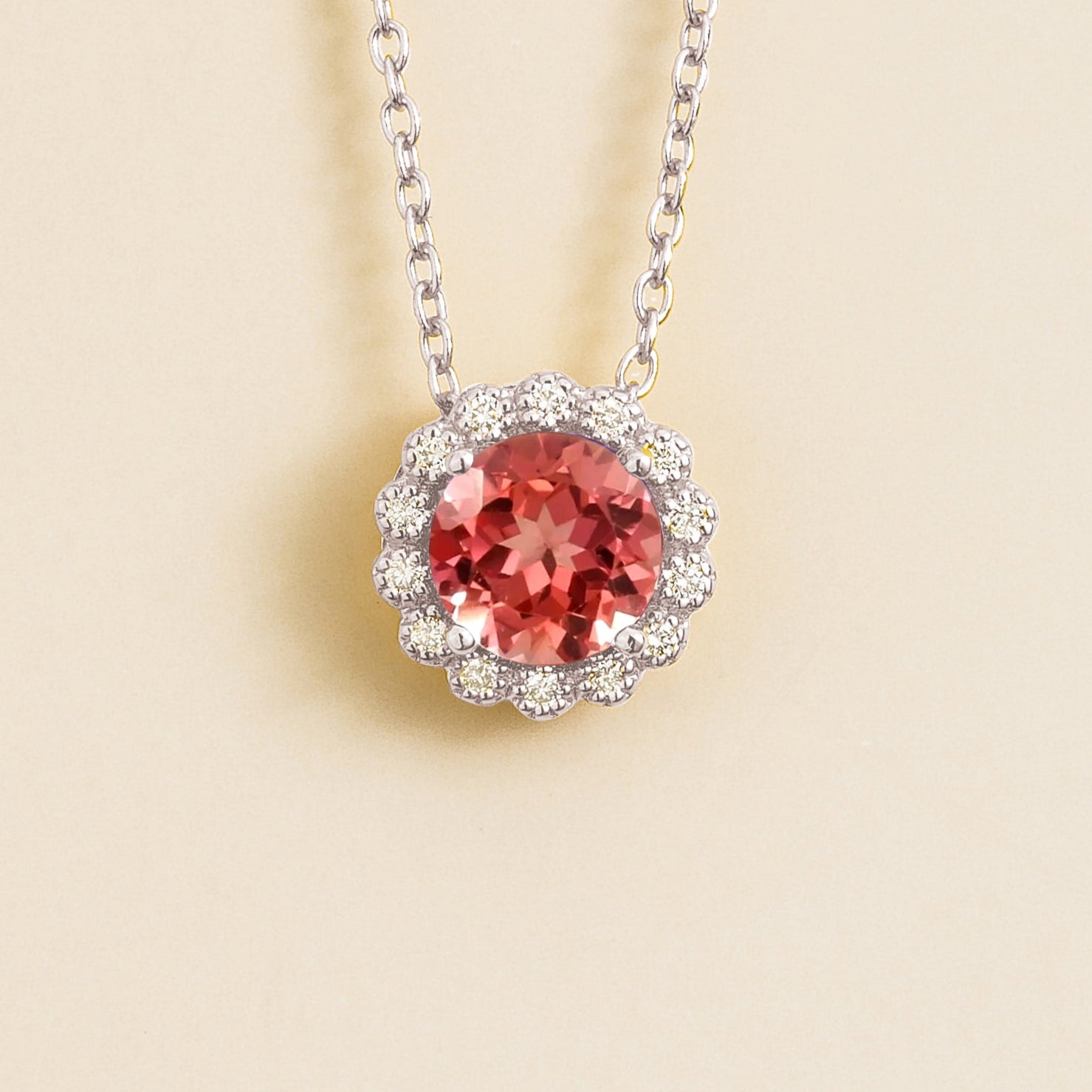 Solen white gold necklace set in Padparadscha sapphire and diamonds.