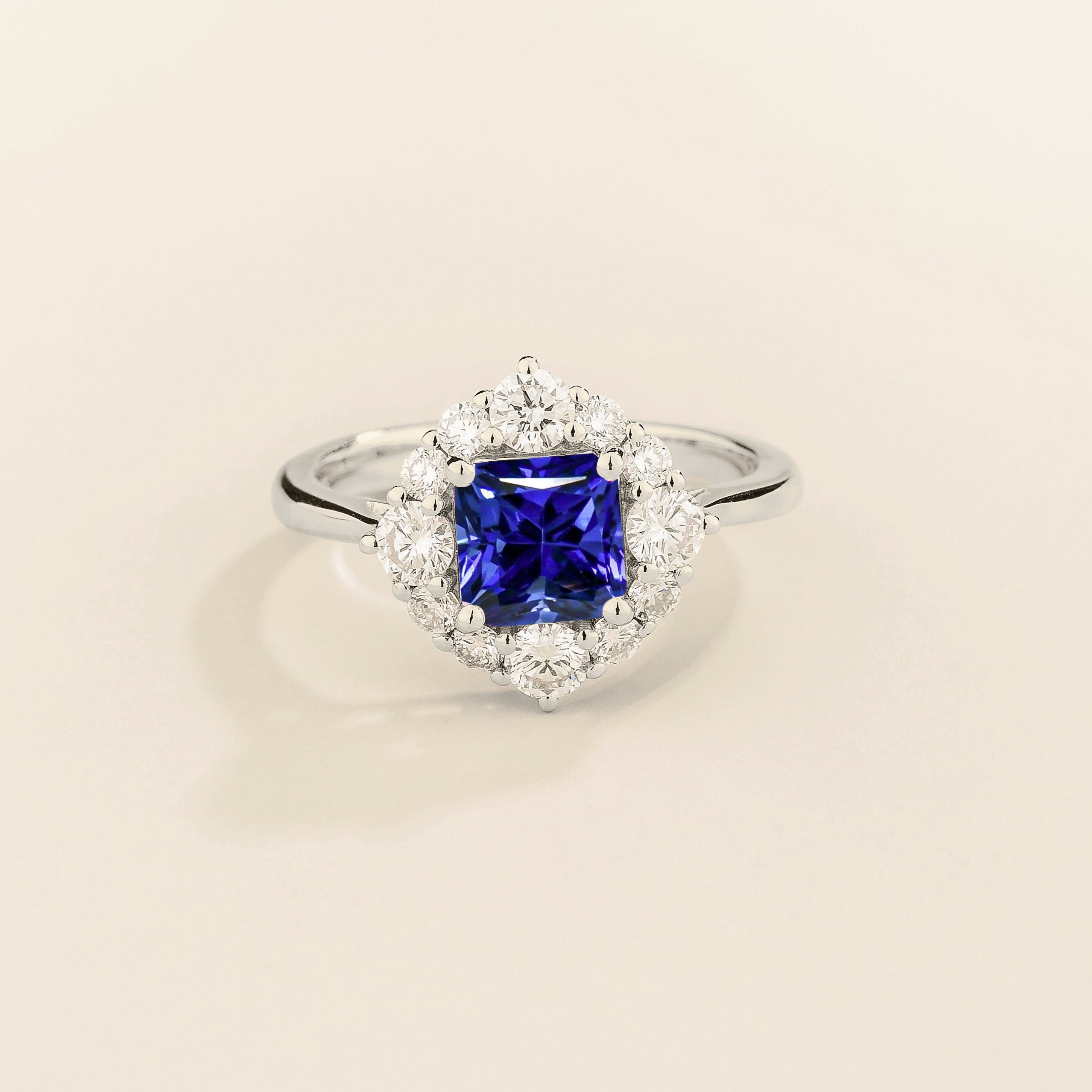 Juvetti white gold ring featuring an octagon-cut lab-grown royal blue sapphire surrounded by round brilliant lab-grown diamonds in a halo design.