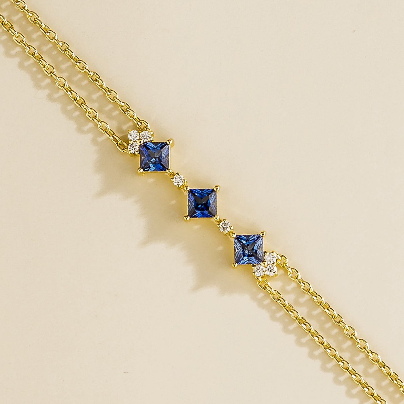 modern gold bracelet with princess cut blue sapphires and lab diamonds