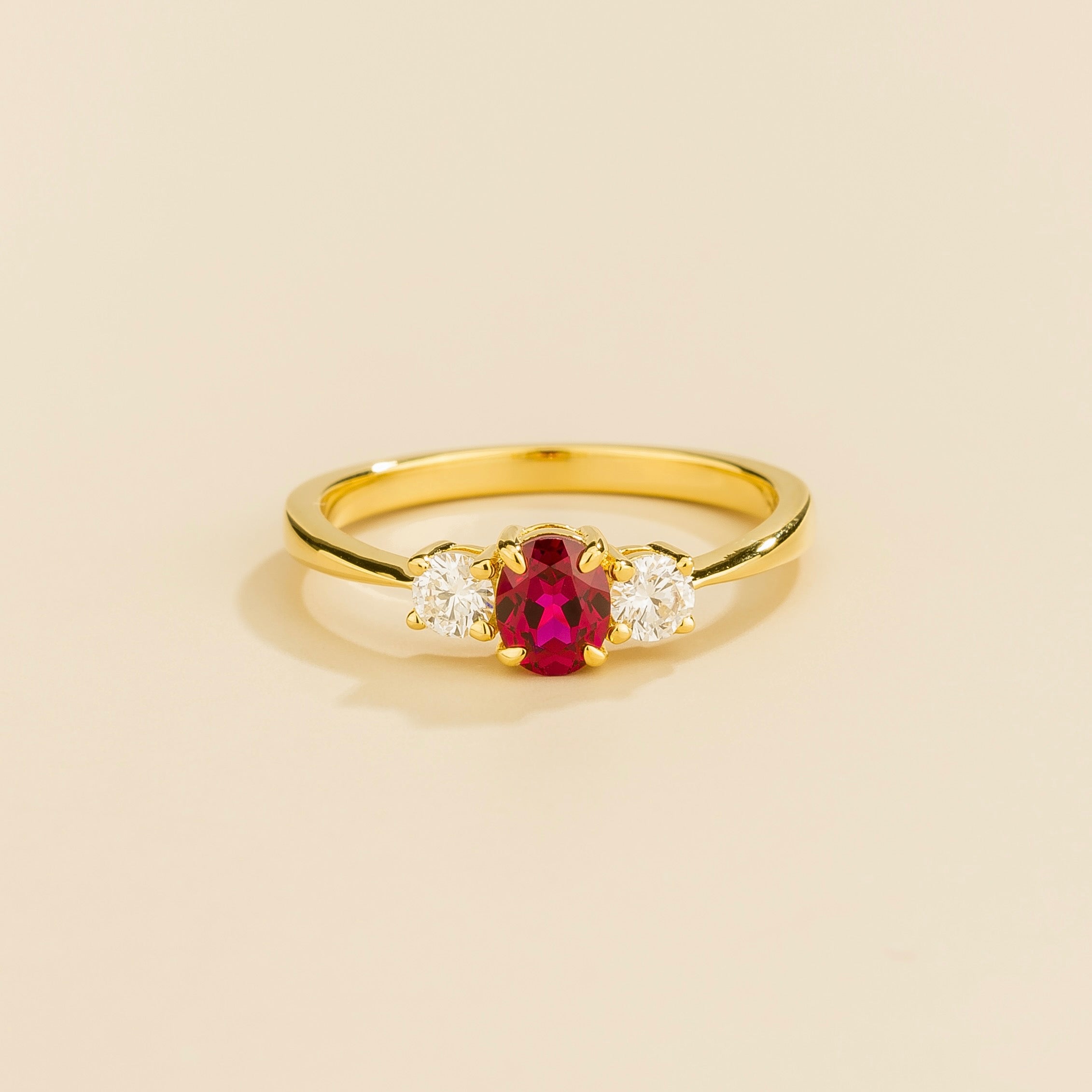 3 gemstones gold ring featuring a central ruby flanked by two diamonds Juvetti London