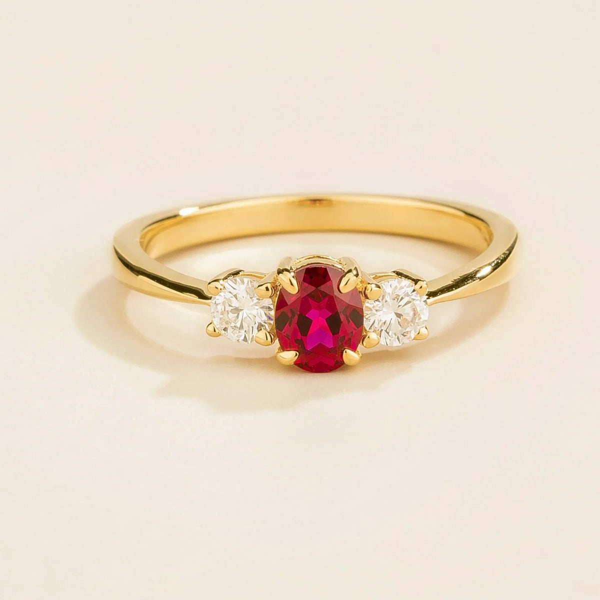 3 gemstones gold ring featuring a central ruby flanked by two diamonds Juvetti London