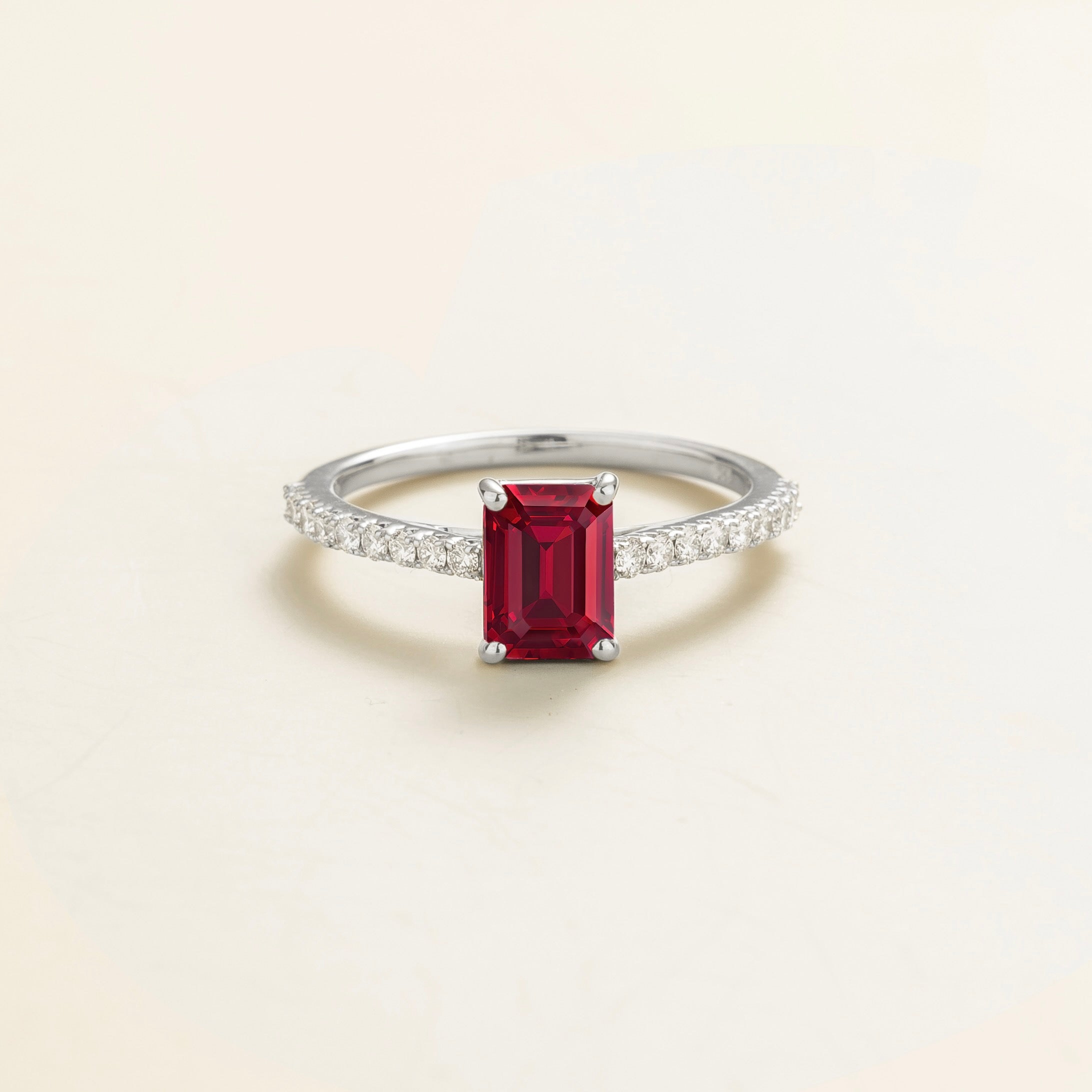 Juvetti white gold fine jewellery ring with lab-grown ruby emerald cut and round lab-grown diamond band.