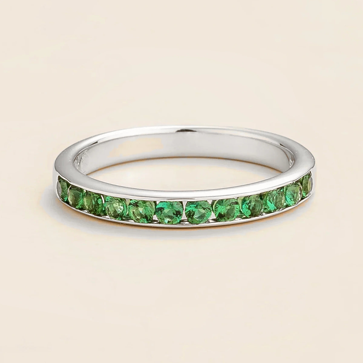 Juvetti white gold channel-set band featuring round lab-grown emerald gemstones.