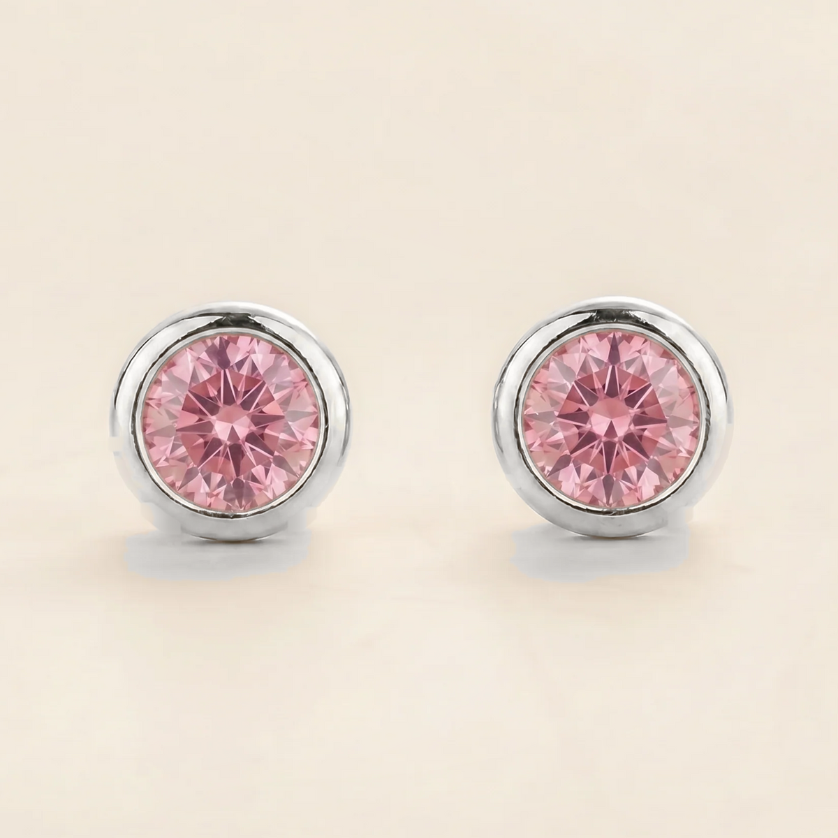 Round lab-grown pink sapphire bezel-set Margo earrings in white gold | Juvetti London
