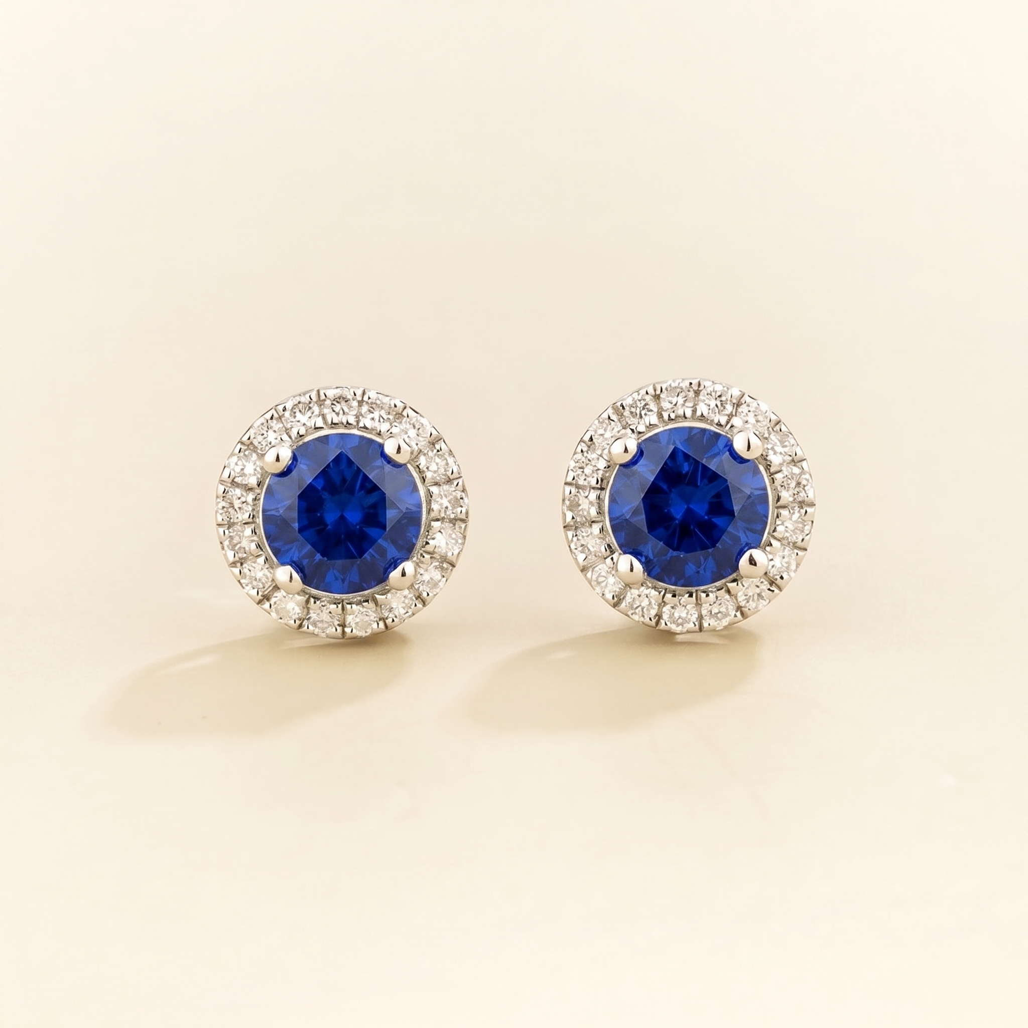Round lab-grown blue sapphire and diamond halo Mars earrings in white gold | Juvetti London