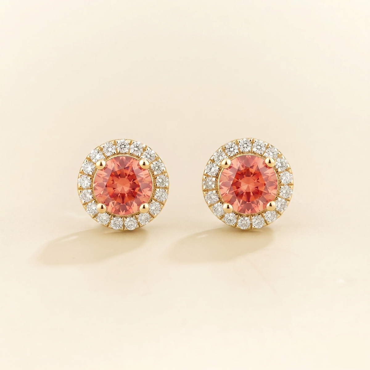 Round lab-grown padparadscha sapphire and diamond halo Mars earrings in gold | Juvetti London