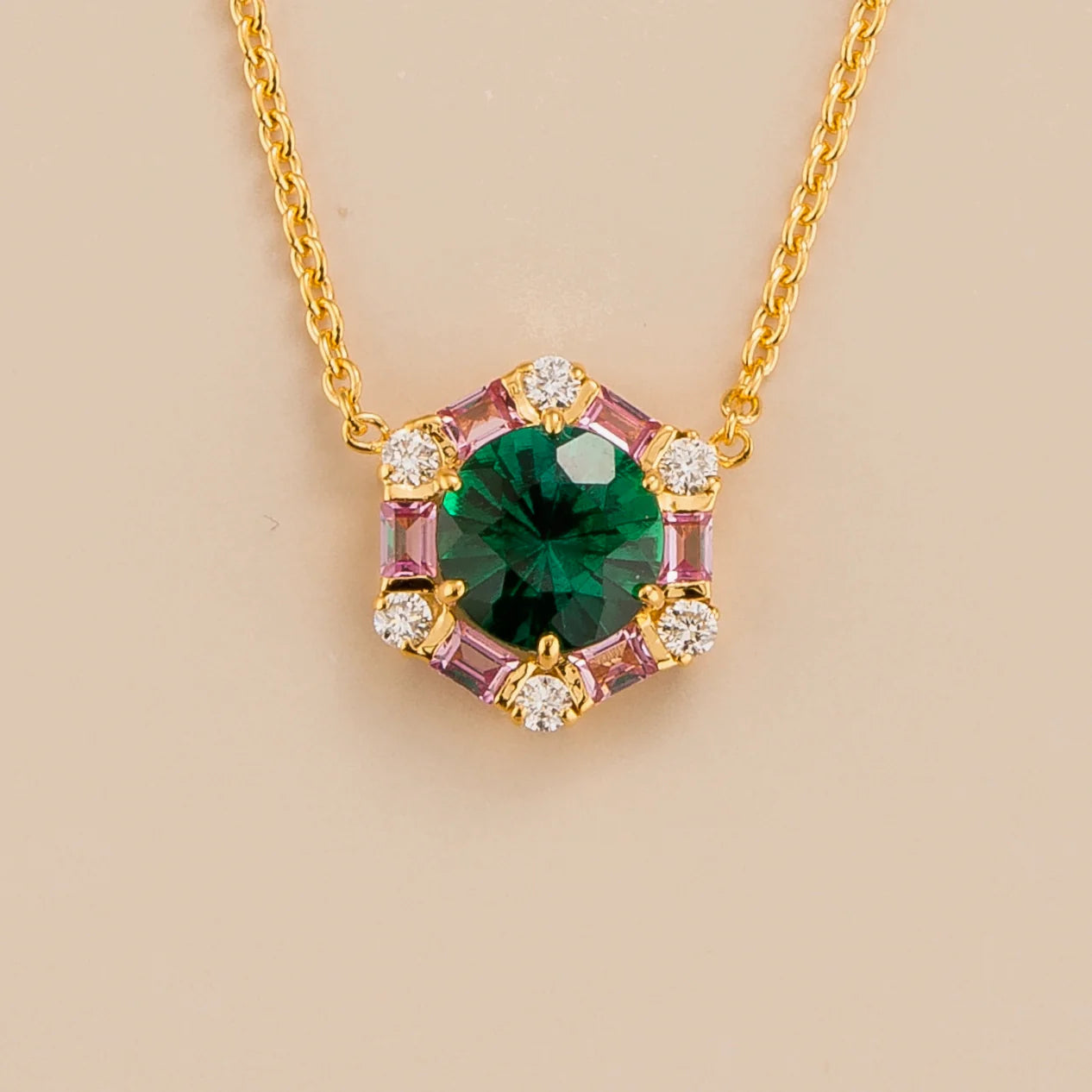 Melba hexagon necklace in 18K gold vermeil set with lab grown emerald, pink sapphire and diamond gem stones.