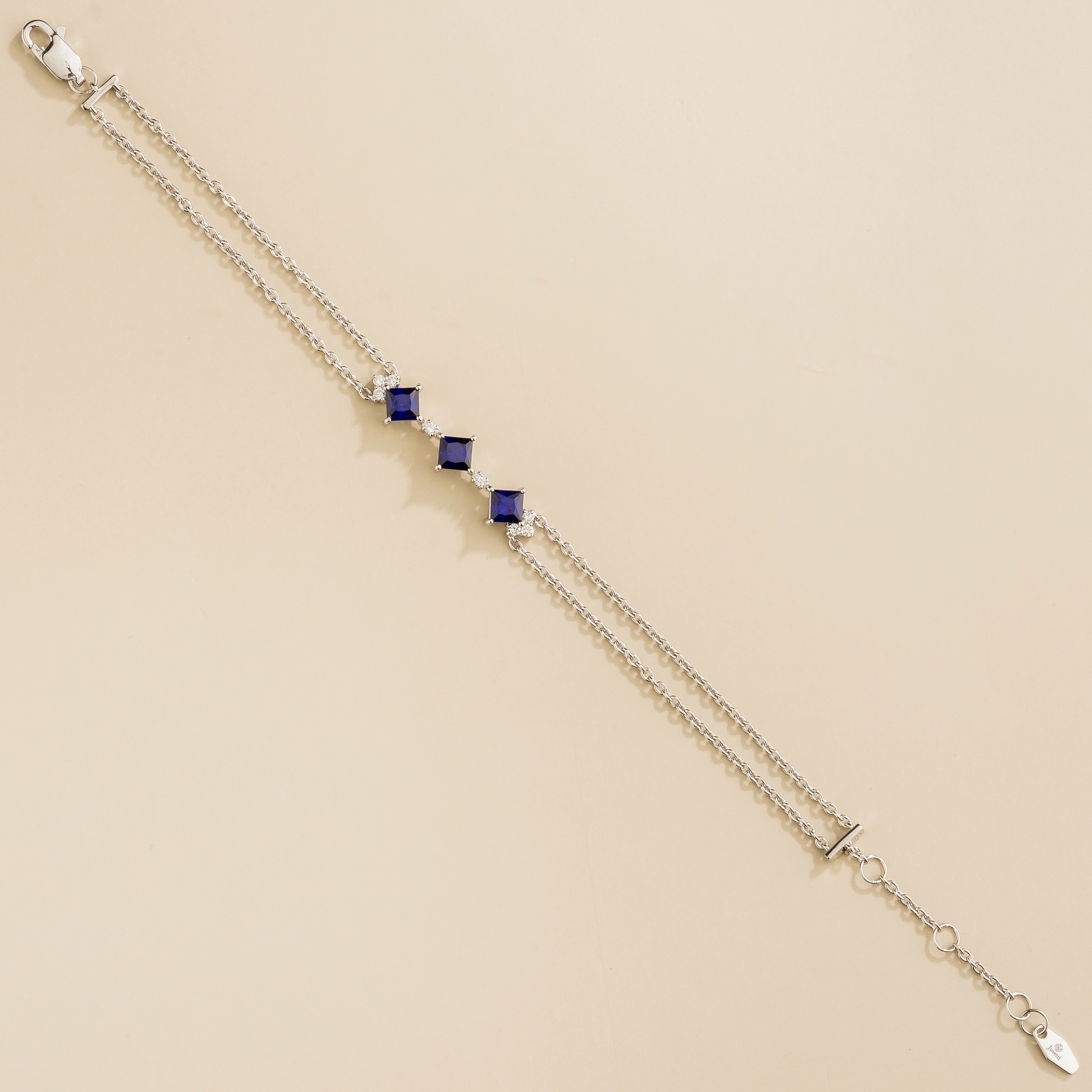 modern double chain bracelet in white gold with blue sapphire and diamond accents
