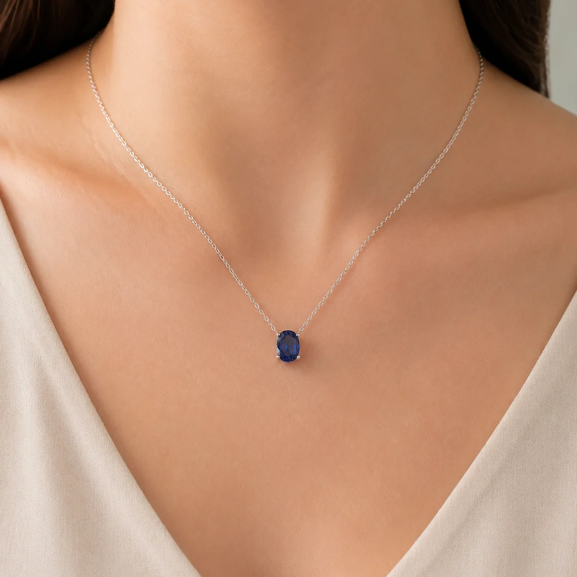 Ovo Blue Sapphire Oval Solitaire Pendant Necklace in White Gold – angle view