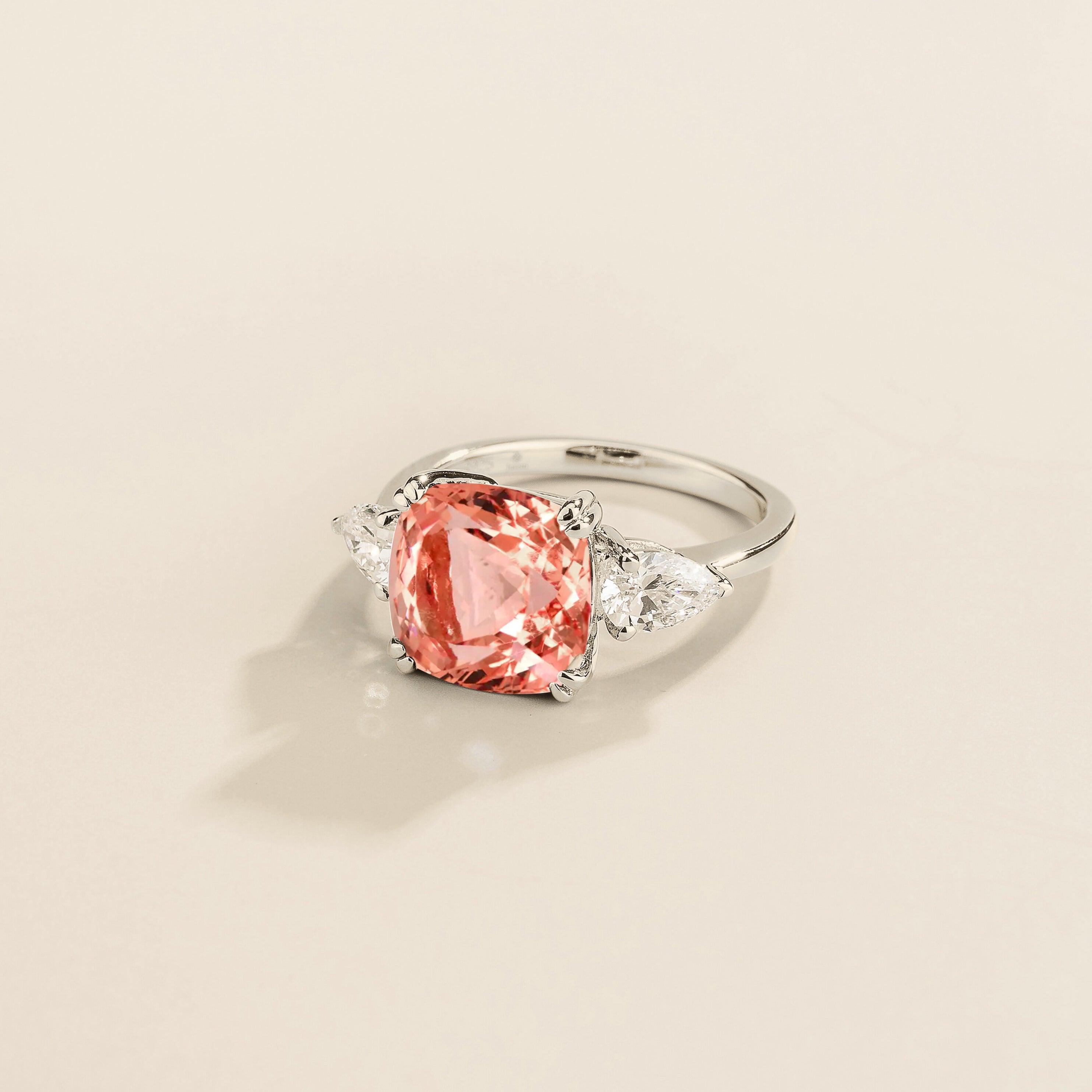 Pari ring in white gold set with Padparadscha Sapphire and Diamonds.