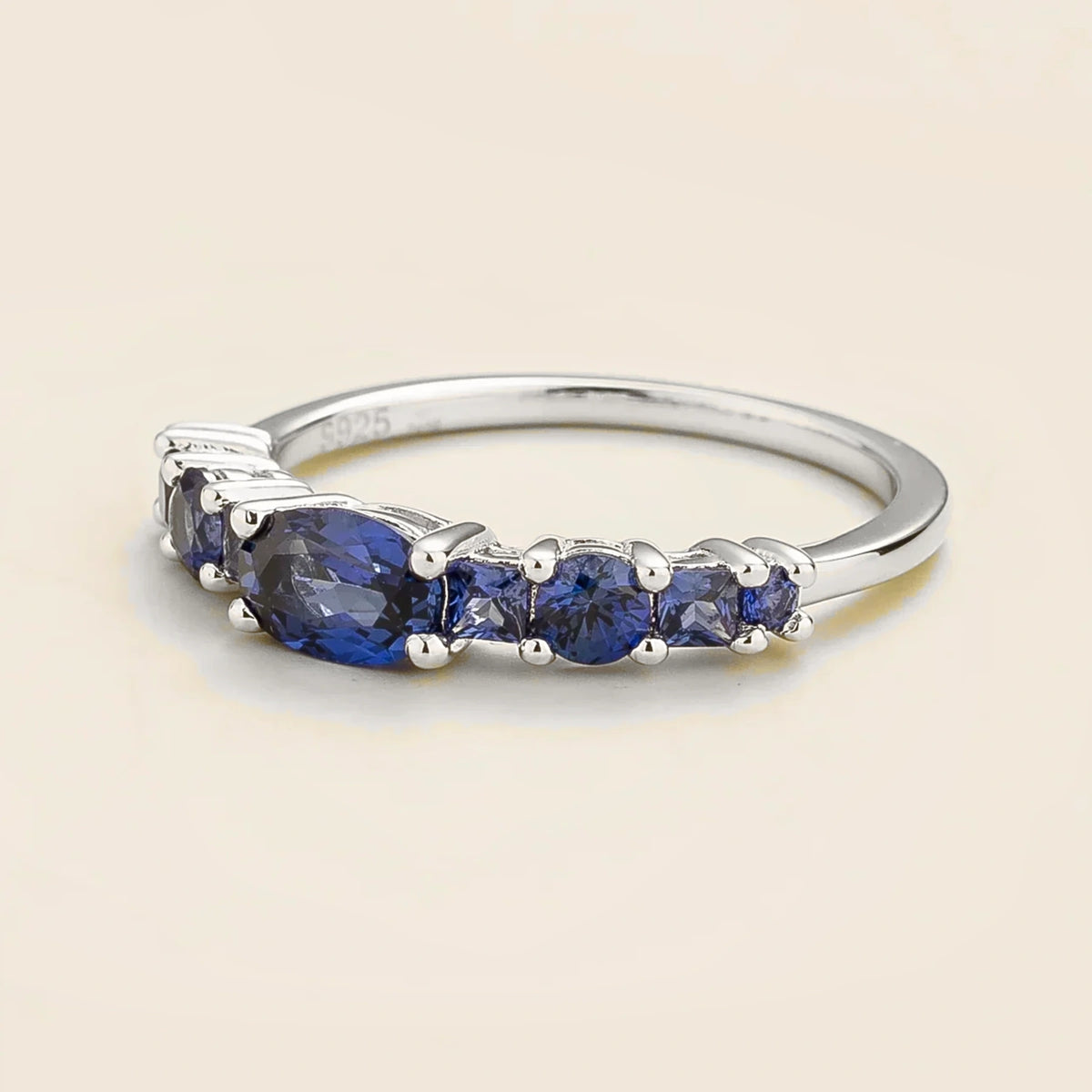 Petra Blue Sapphire Graduated Band Ring in White Gold – angle view