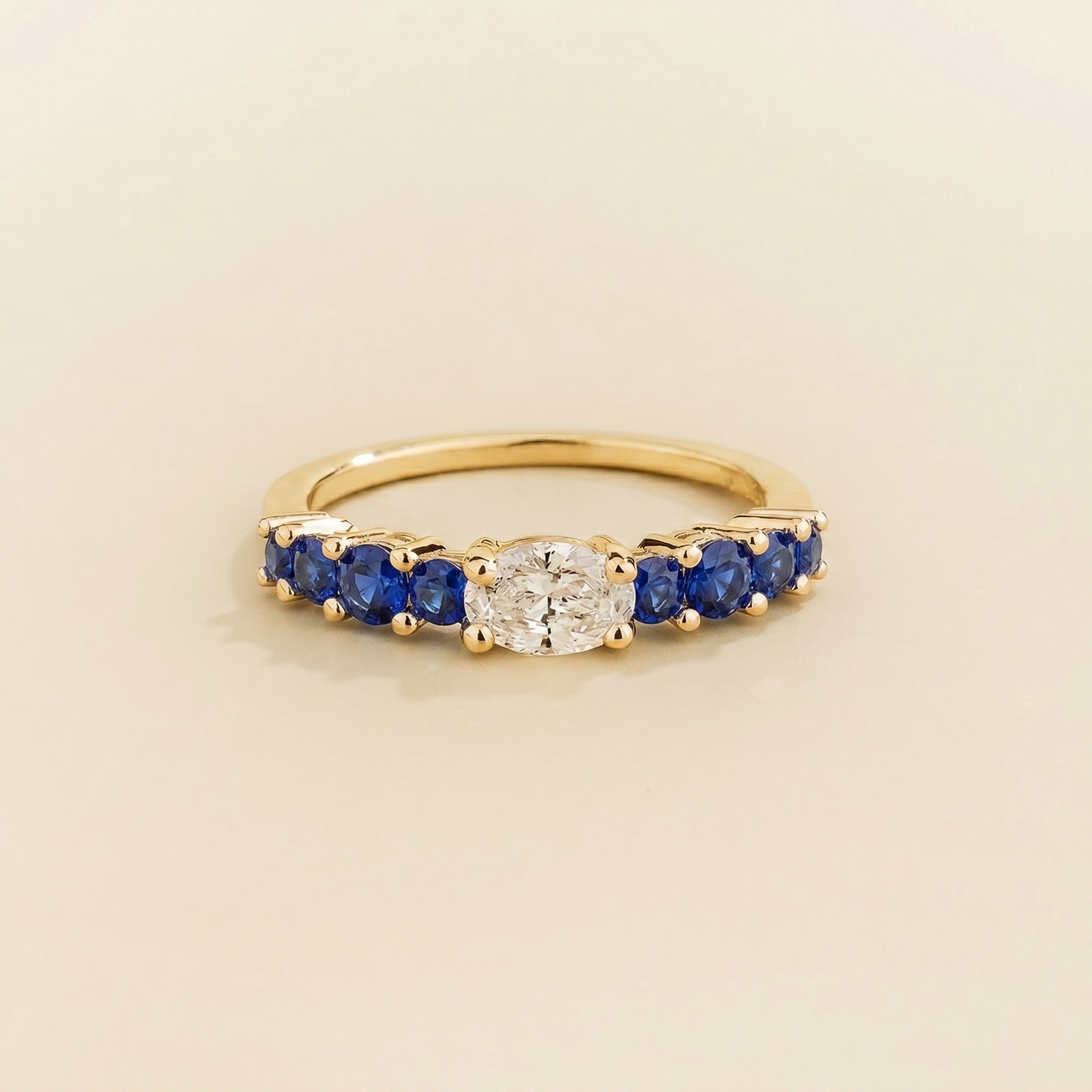 Petra Oval Diamond and Blue Sapphire Half Eternity Ring in Gold