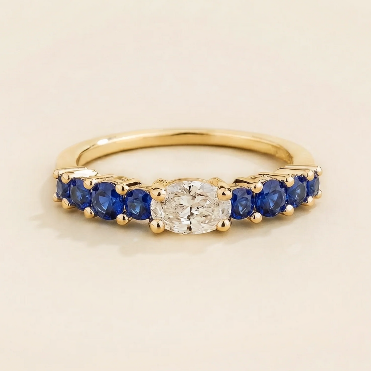 Petra Oval Diamond & Blue Sapphire Half Eternity Ring in Gold | Juvetti